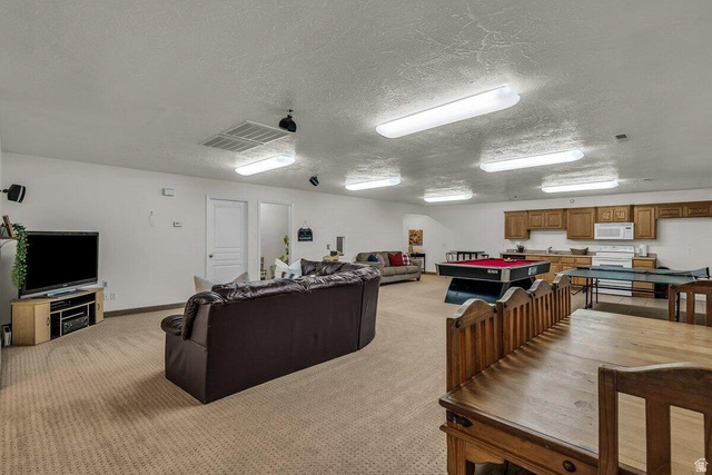 841 1010 S Street St. George, UT 84790 - Photo 18 of 33 Living area featuring light carpet, a textured ceiling, and pool table
