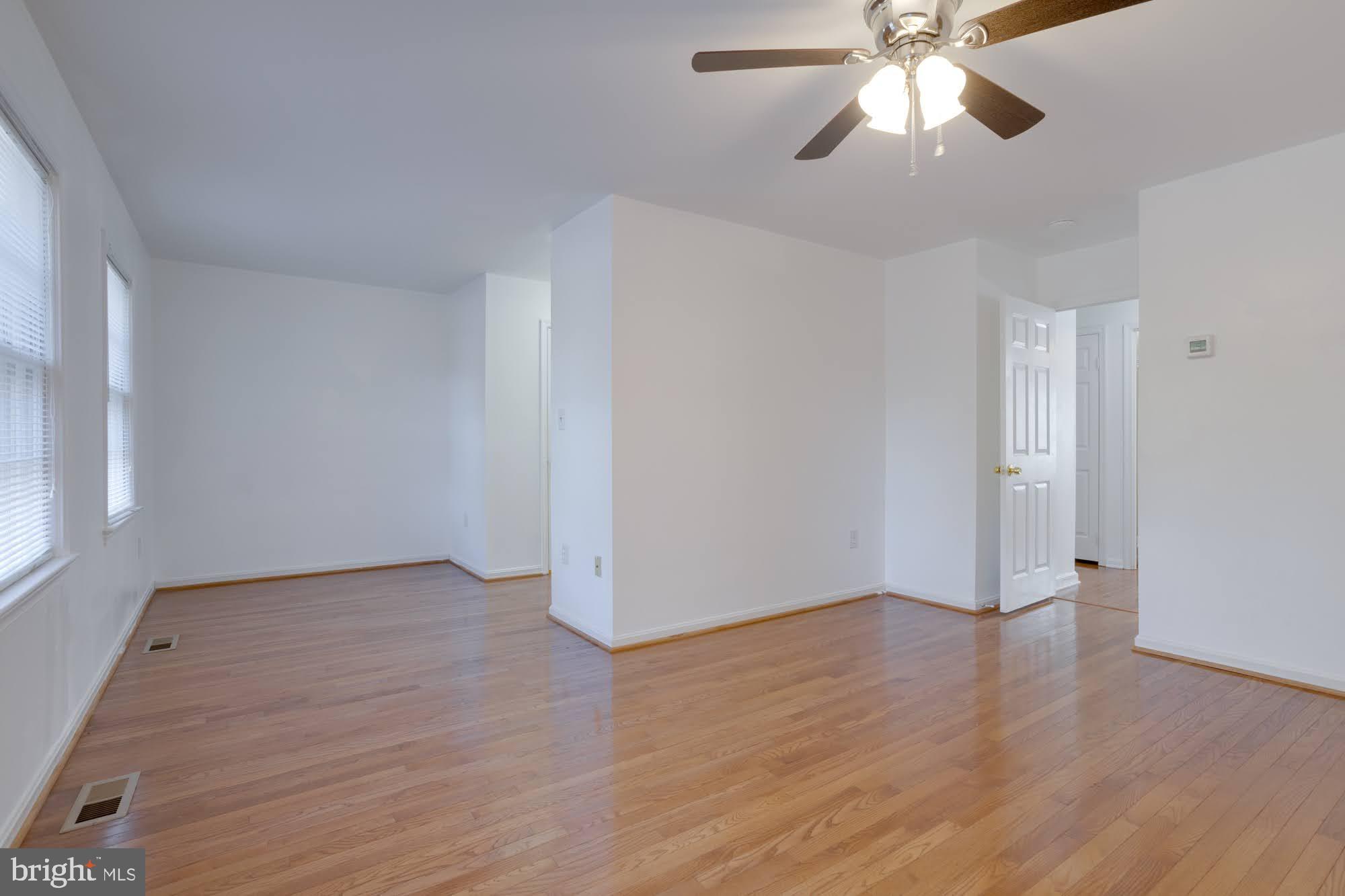 9043 Blarney Stone Drive Springfield, VA 22152 - Photo 14 of 23 an empty room with wooden floor chandelier fan and closet area