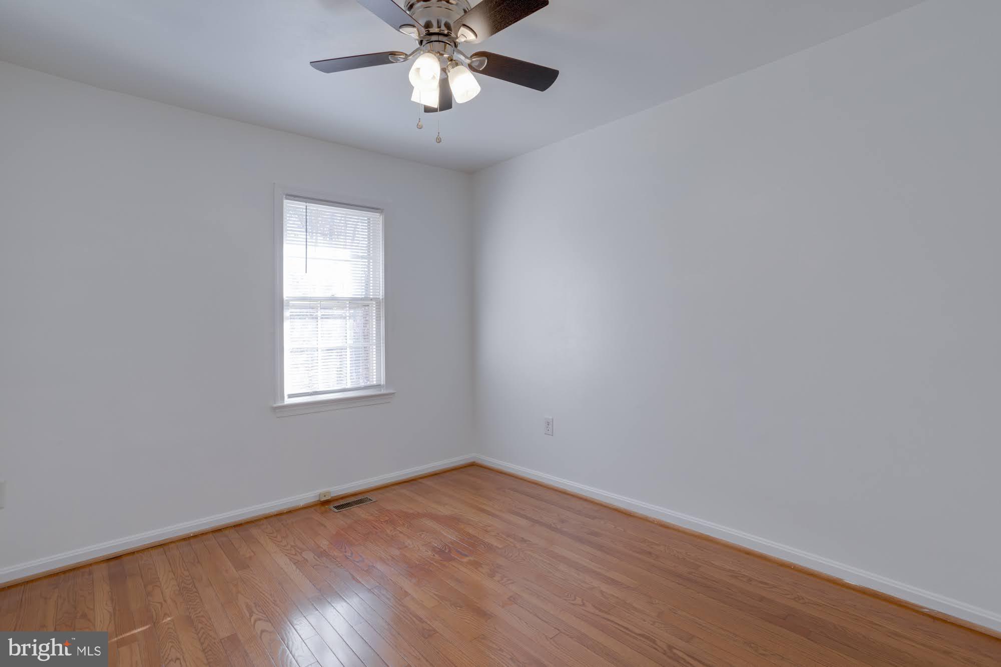9043 Blarney Stone Drive Springfield, VA 22152 - Photo 18 of 23 wooden floor in an empty room with a window