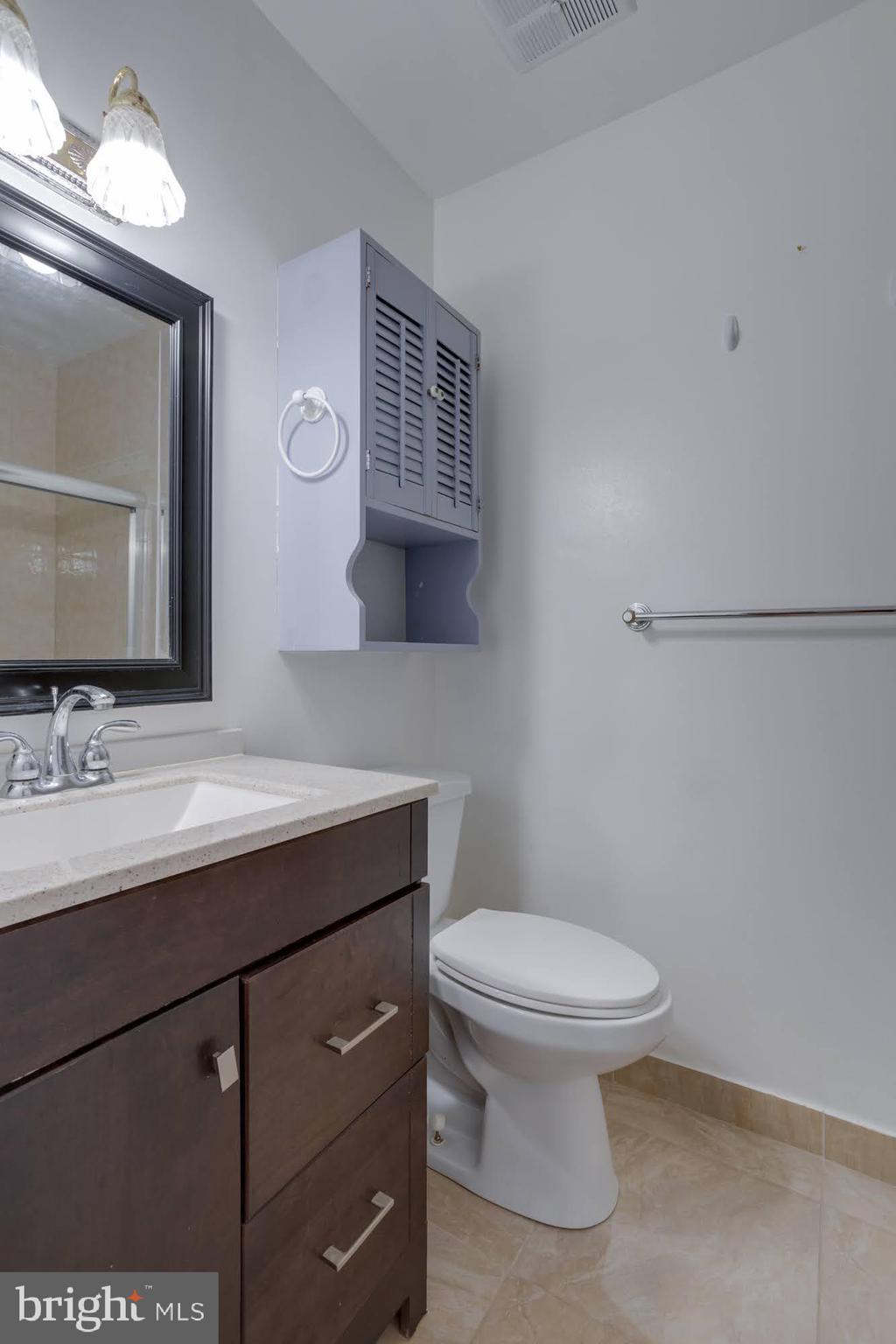 9043 Blarney Stone Drive Springfield, VA 22152 - Photo 19 of 23 a bathroom with a toilet a sink and mirror