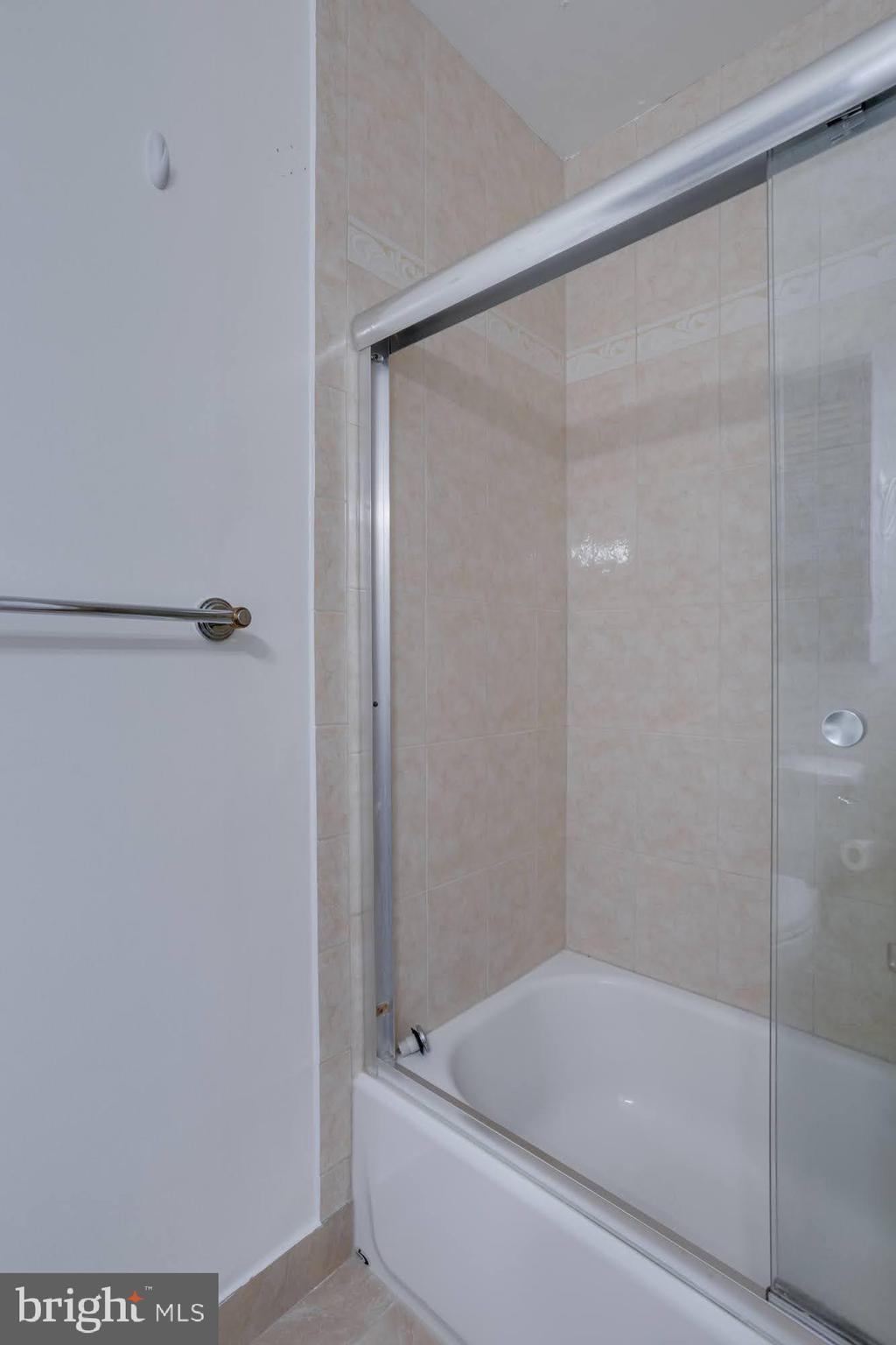 9043 Blarney Stone Drive Springfield, VA 22152 - Photo 20 of 23 a bathroom with a shower and a bath tub