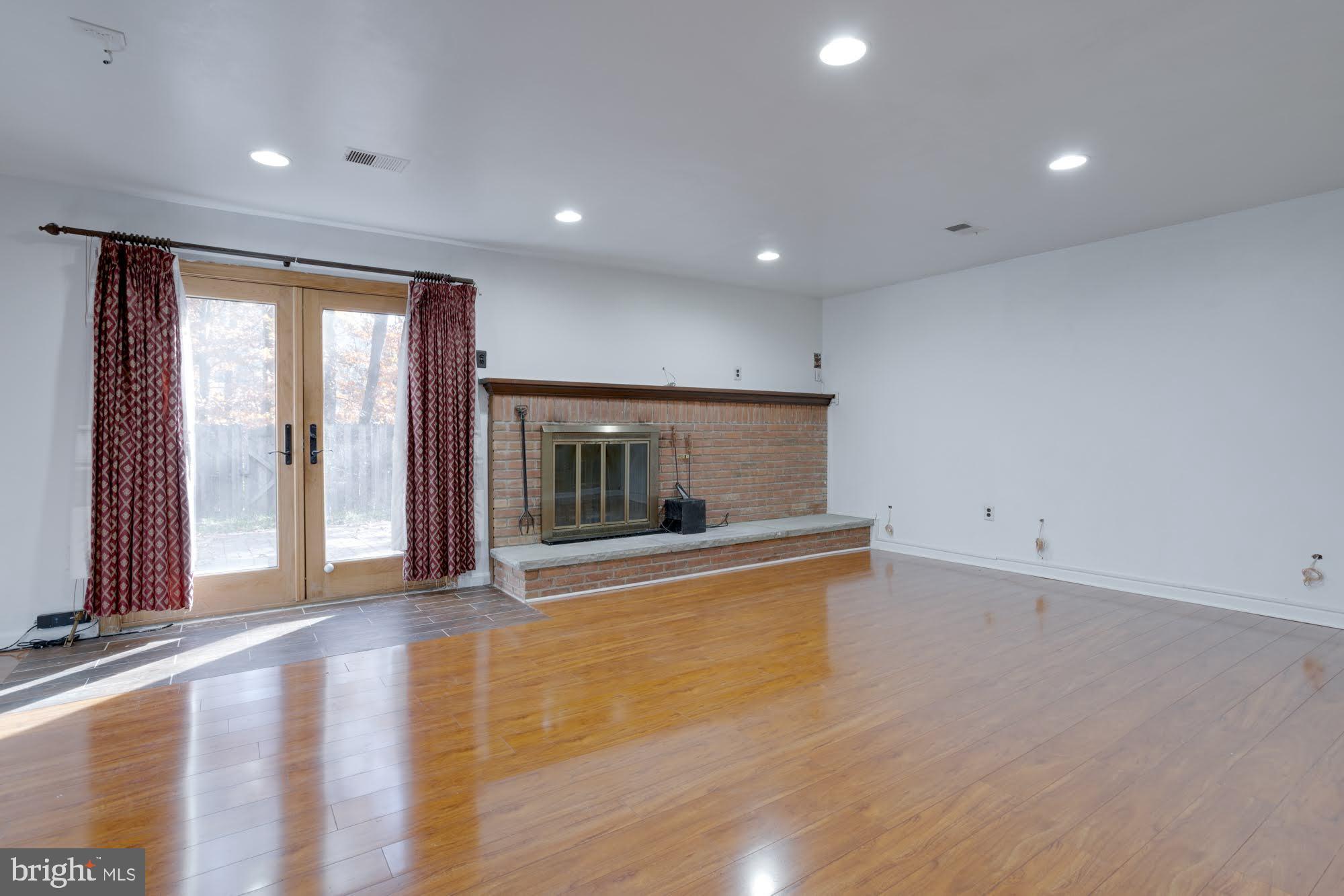 9043 Blarney Stone Drive Springfield, VA 22152 - Photo 2 of 23 an empty room with wooden floor and windows