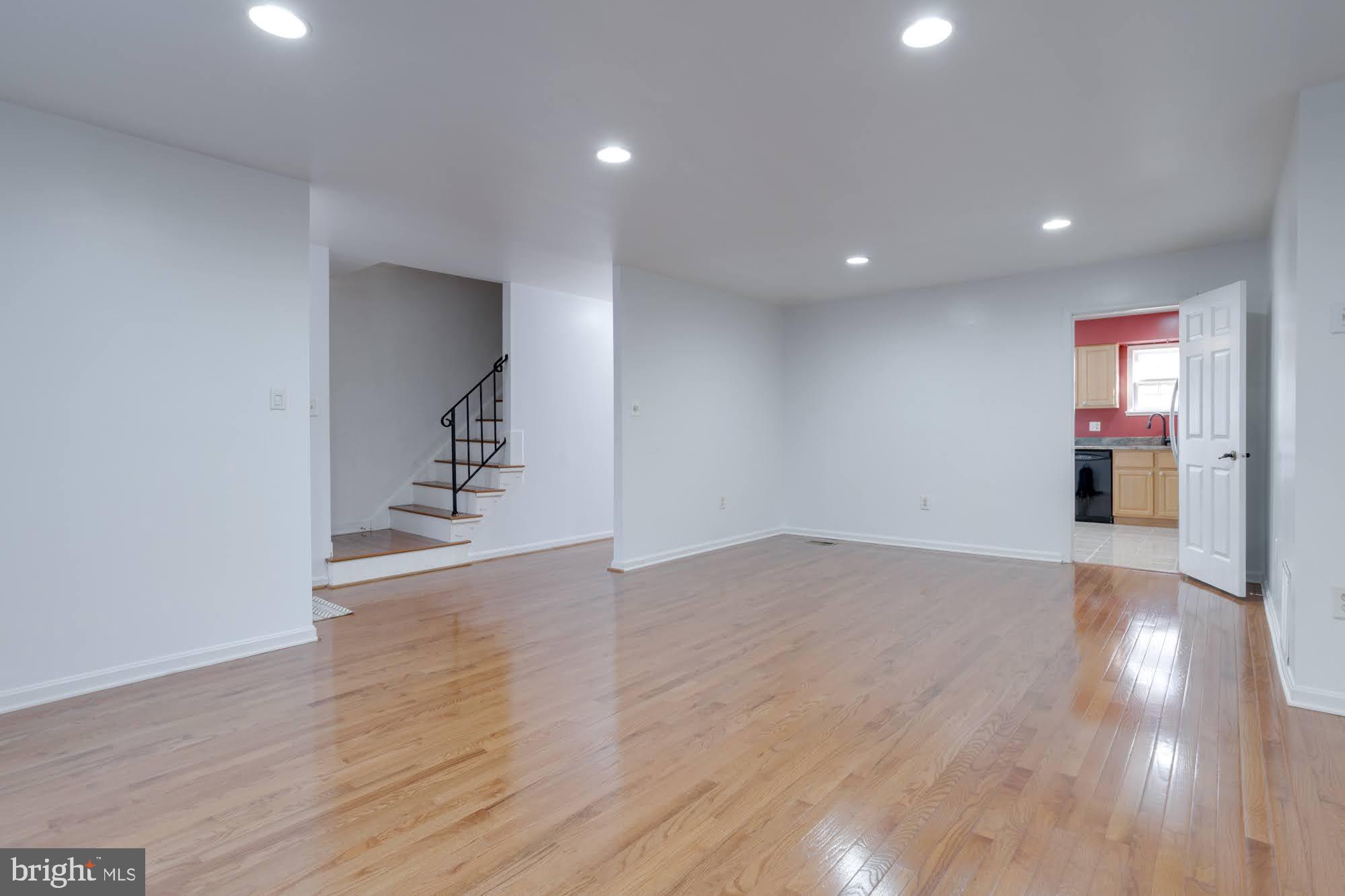 9043 Blarney Stone Drive Springfield, VA 22152 - Photo 4 of 23 a view of an empty room with wooden floor and a window