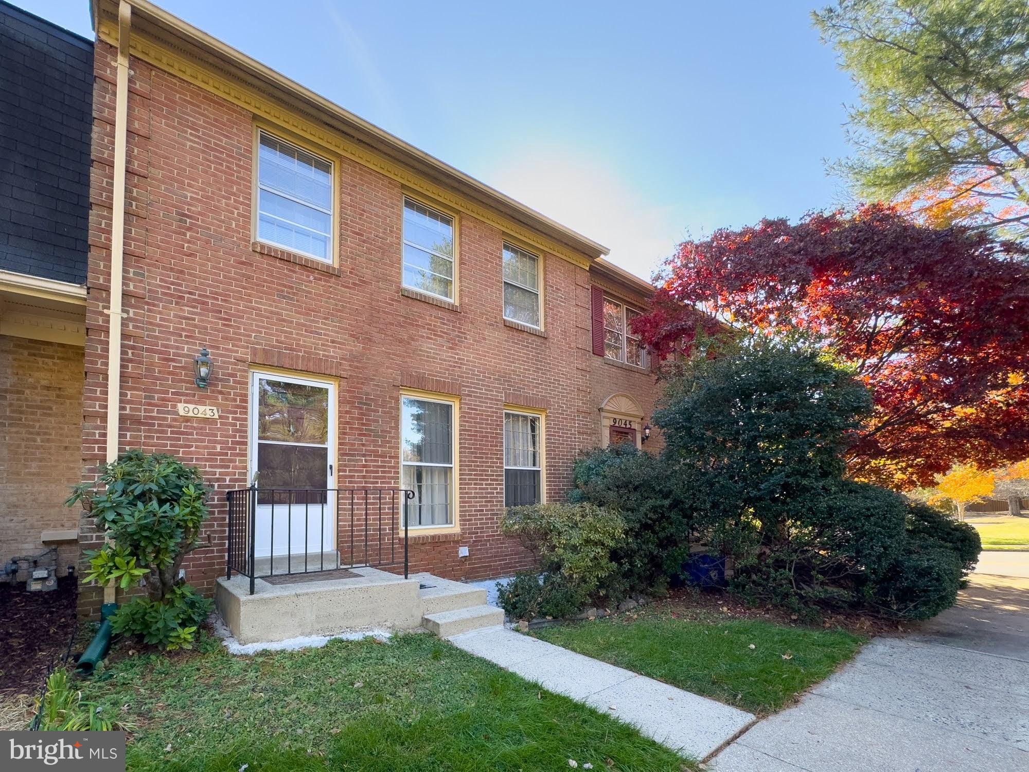 9043 Blarney Stone Drive Springfield, VA 22152 - Photo 5 of 23 a front view of a house with a garden