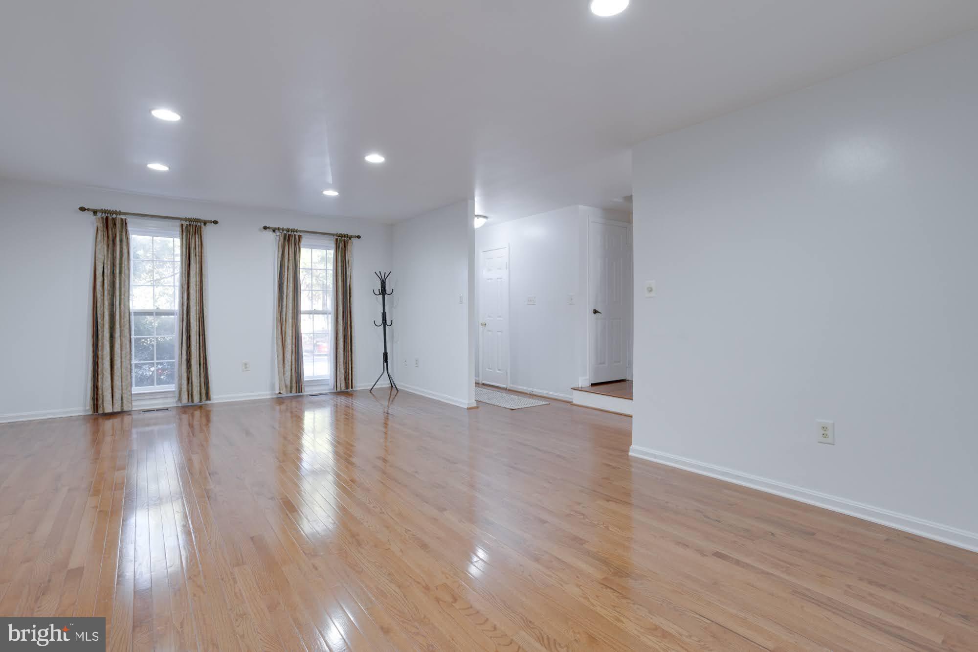 9043 Blarney Stone Drive Springfield, VA 22152 - Photo 6 of 23 a view of an empty room with wooden floor and windows