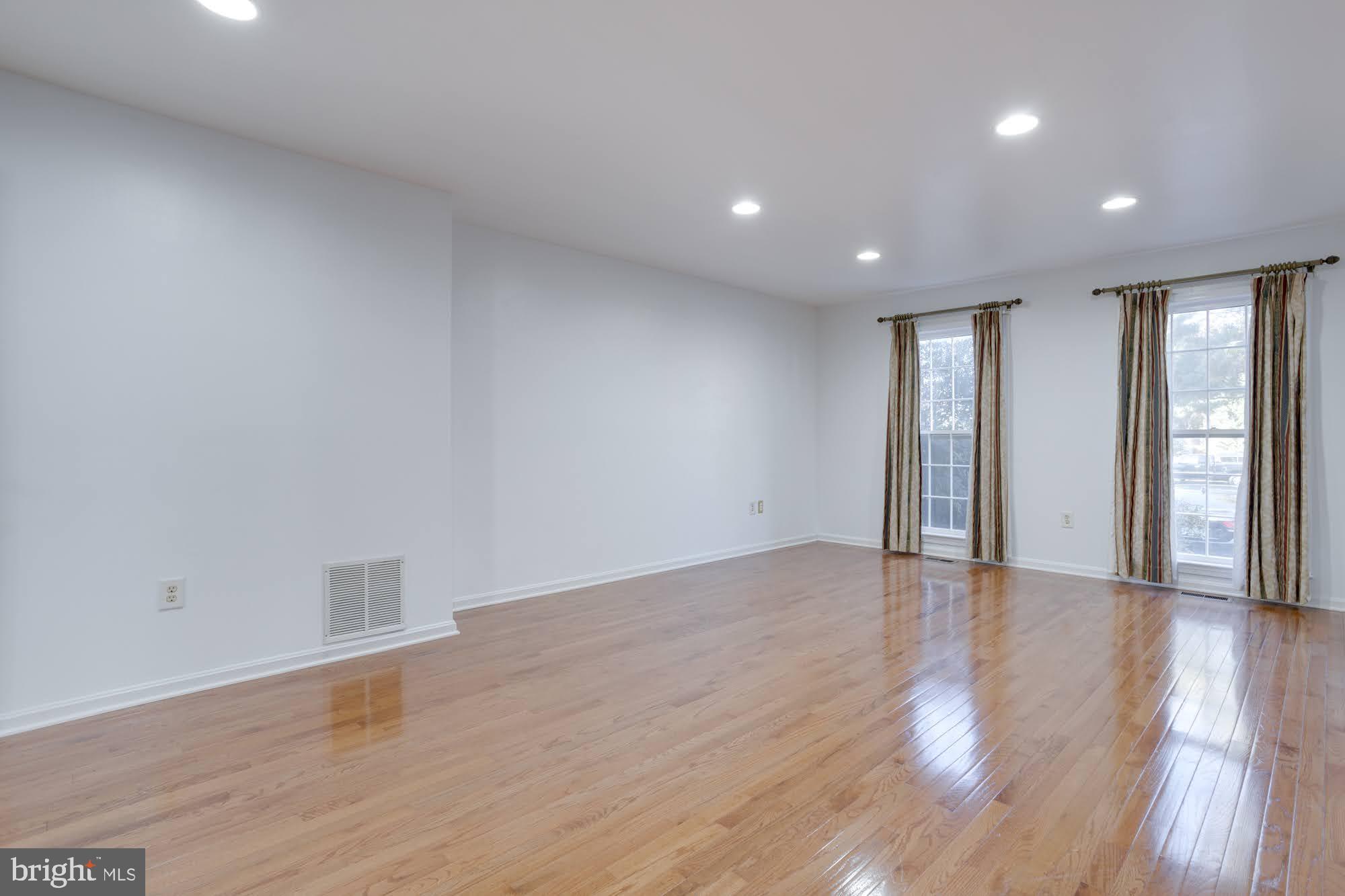9043 Blarney Stone Drive Springfield, VA 22152 - Photo 7 of 23 a view of an empty room with wooden floor and a window