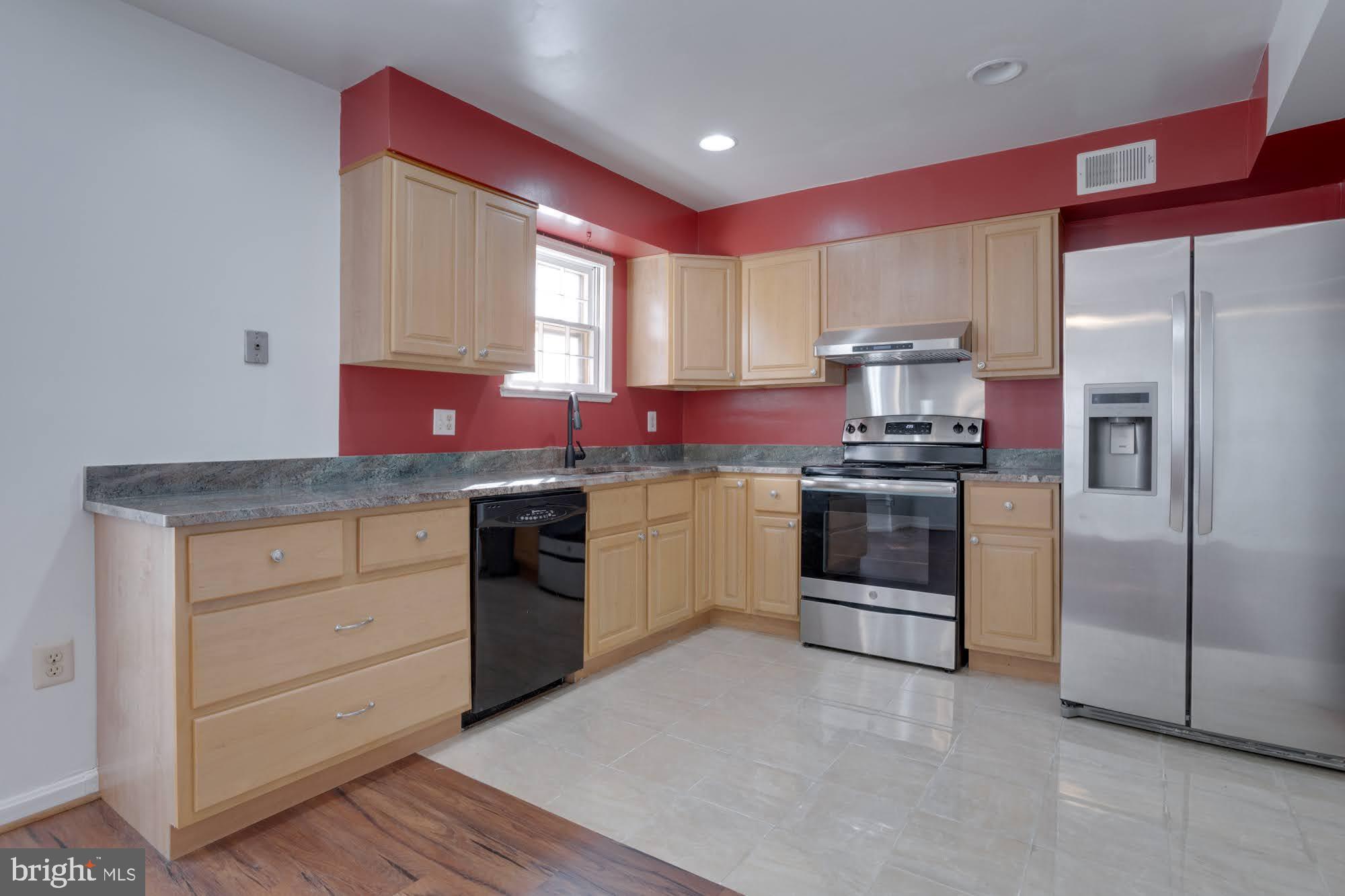 9043 Blarney Stone Drive Springfield, VA 22152 - Photo 10 of 23 a kitchen with stainless steel appliances granite countertop a stove a sink and a refrigerator