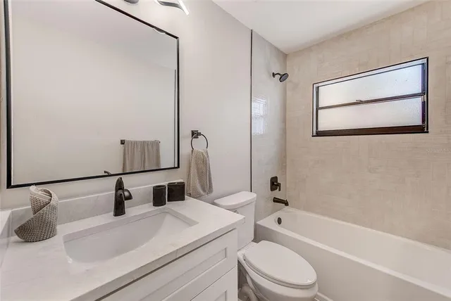 a view of a house with backyard and wooden fence