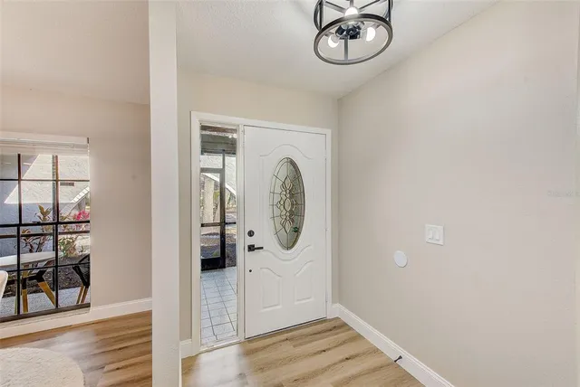 a view of a room with wooden floor and white walls