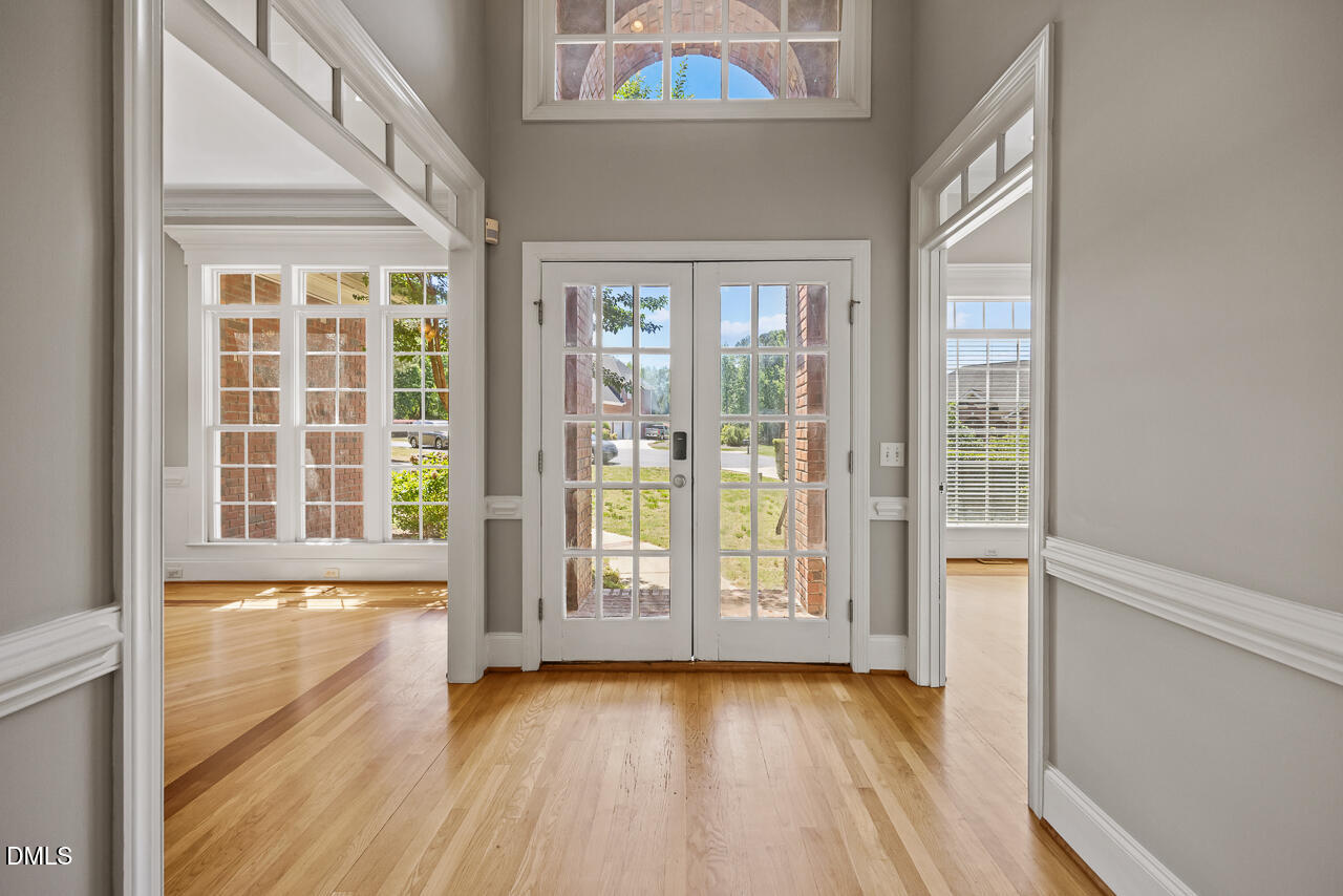 4004 Frontenac Court Apex, NC 27539 - Photo 4 of 61 a view of an empty room with wooden floor and a window
