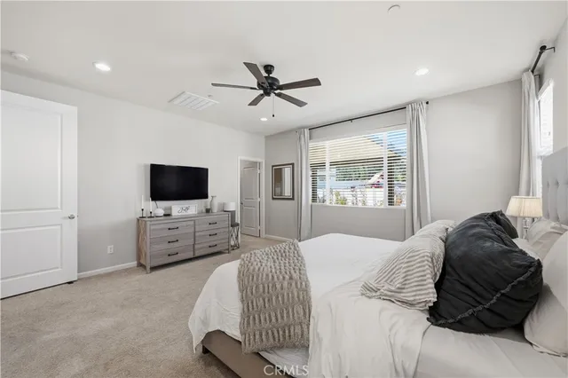 a large bathroom with a double vanity sink a large mirror and a bathtub