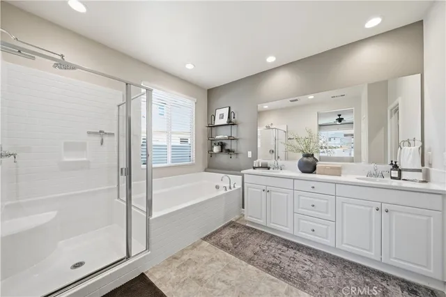 a spacious bathroom with a tub shower vanity and a sink