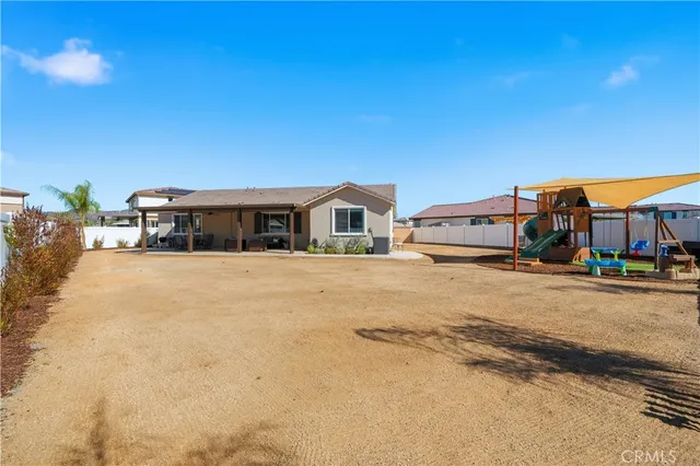 a view of a hallway with wooden floor and a window