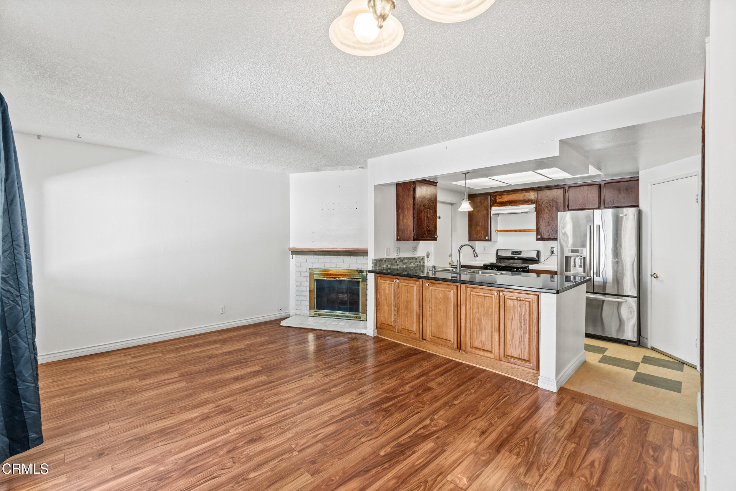 3330 Ketch Avenue Oxnard, CA 93035 - Photo 13 of 45 a large kitchen with wooden floor and stainless steel appliances