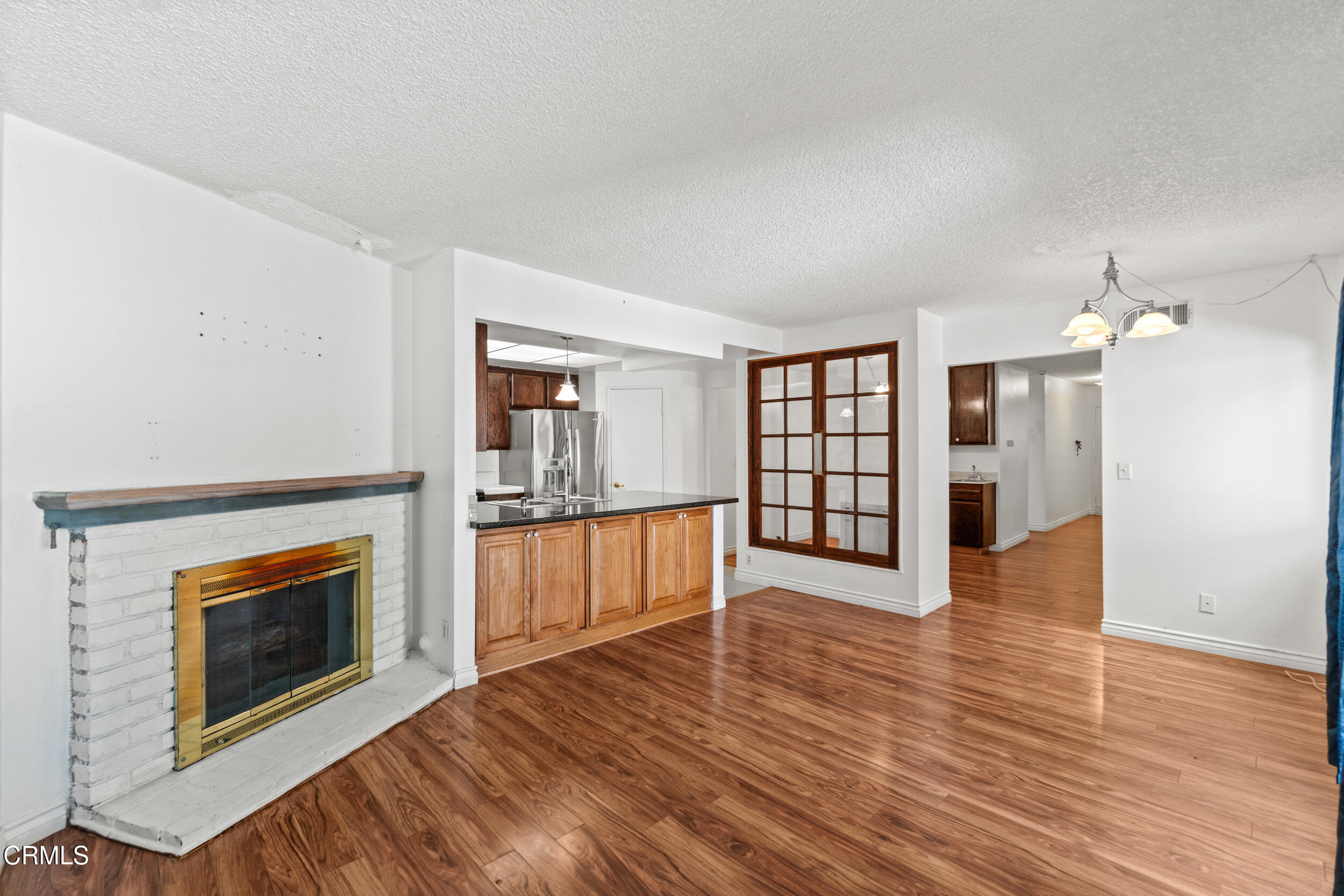 3330 Ketch Avenue Oxnard, CA 93035 - Photo 14 of 45 a view of a livingroom with wooden floor and a fireplace