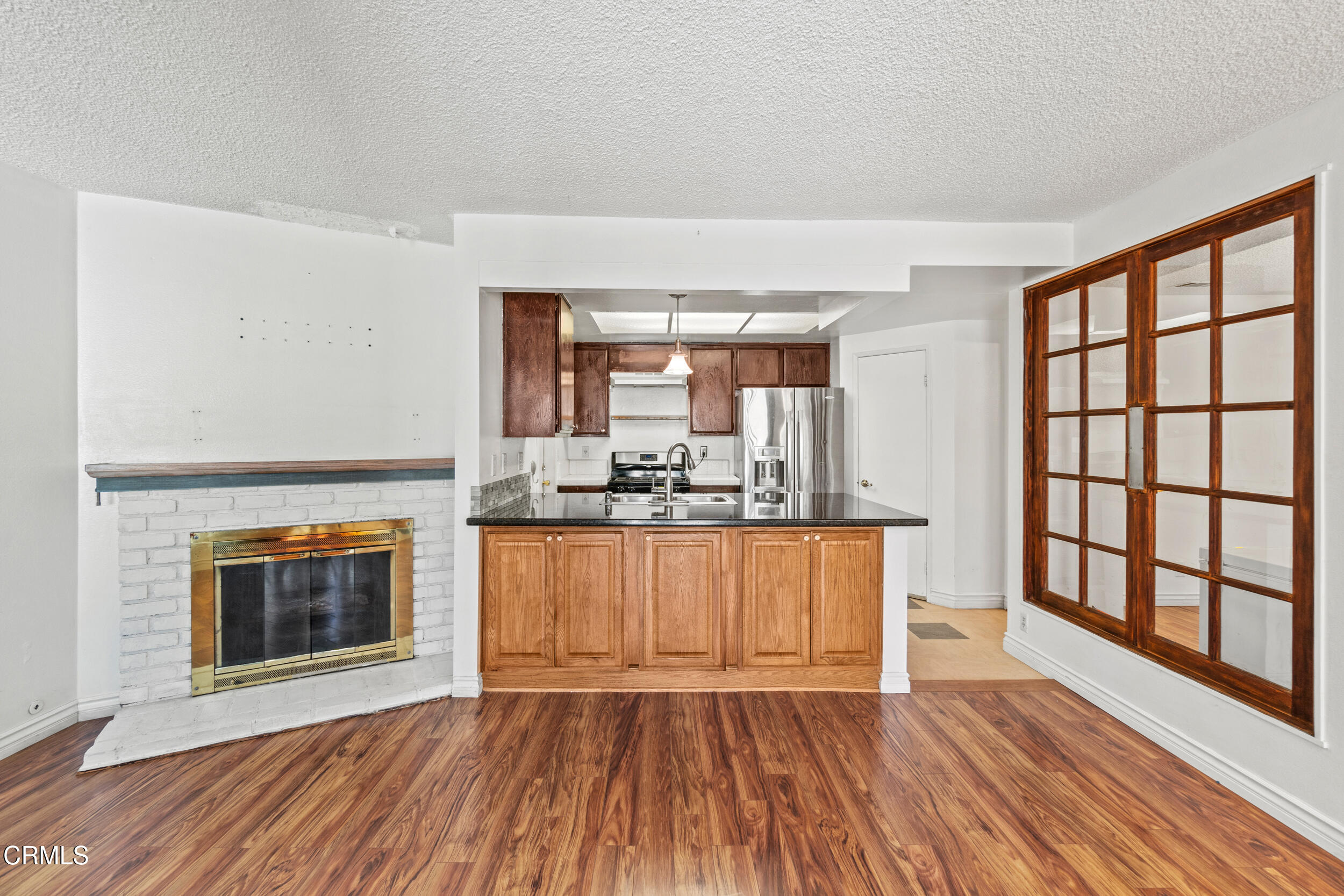 3330 Ketch Avenue Oxnard, CA 93035 - Photo 15 of 45 a view of an empty room with a fireplace and a window