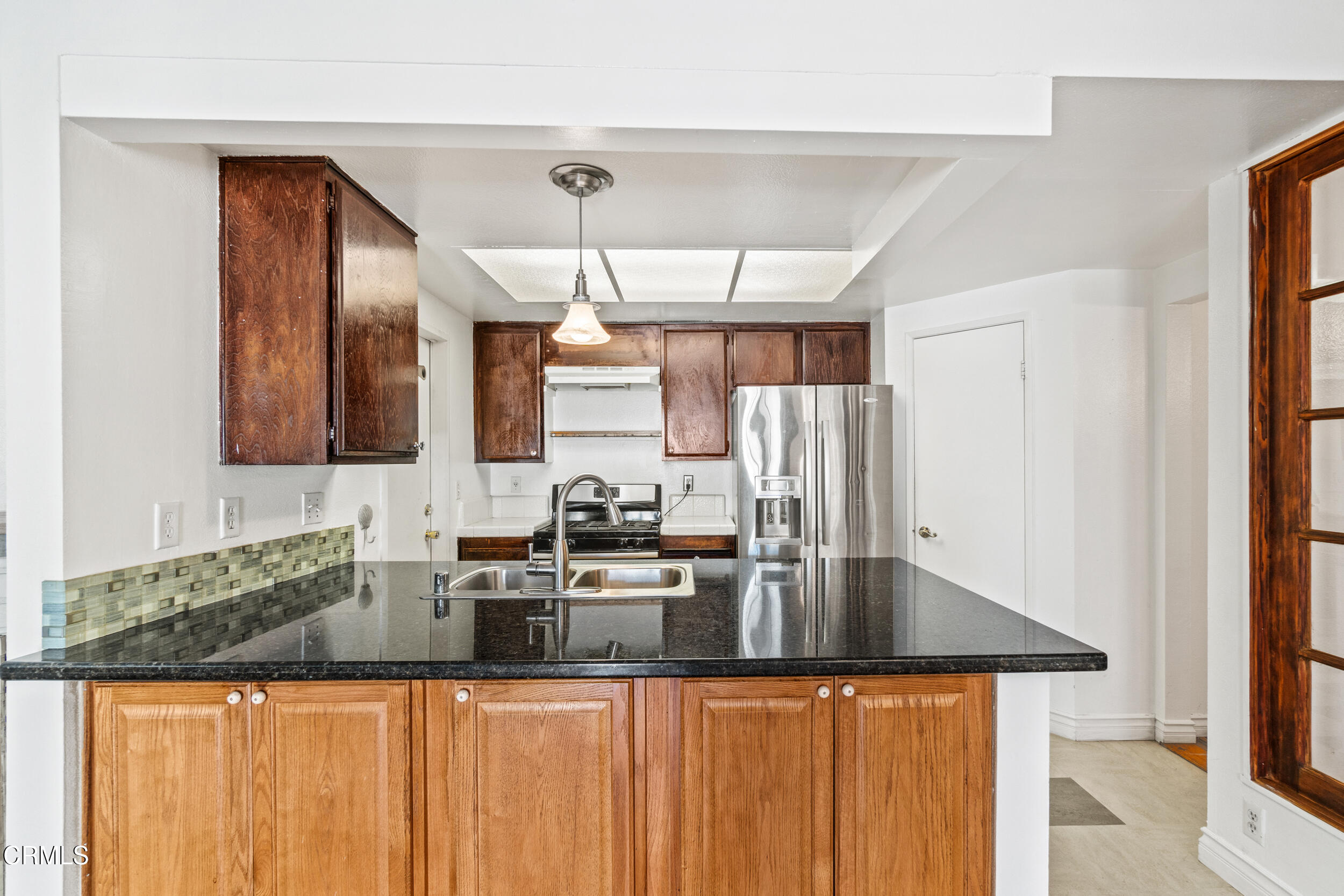 3330 Ketch Avenue Oxnard, CA 93035 - Photo 16 of 45 a kitchen with granite countertop a sink and cabinets