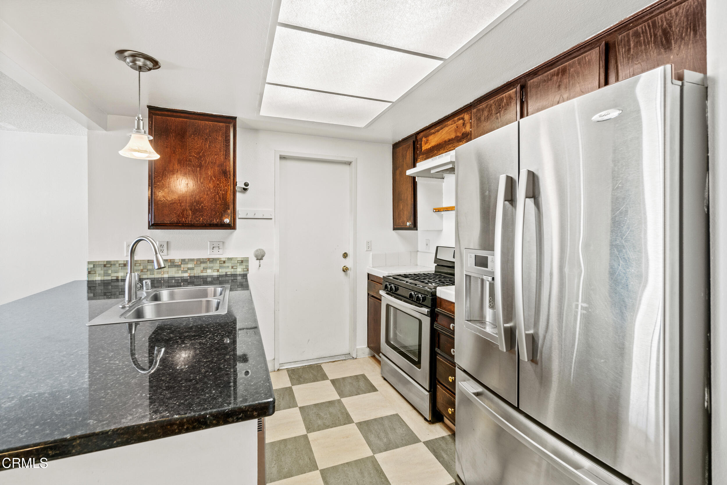 3330 Ketch Avenue Oxnard, CA 93035 - Photo 17 of 45 a kitchen with stainless steel appliances granite countertop a refrigerator a stove and a sink