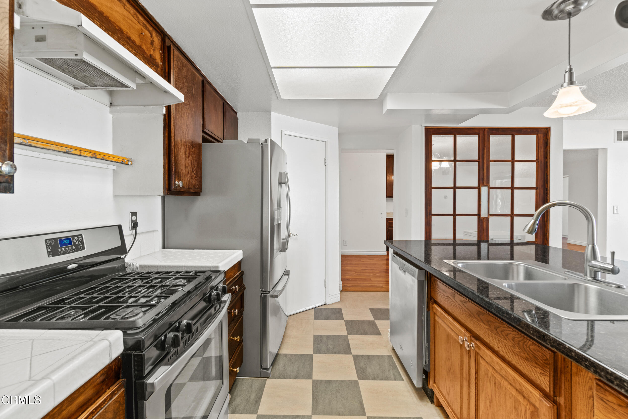3330 Ketch Avenue Oxnard, CA 93035 - Photo 19 of 45 a kitchen with stainless steel appliances granite countertop a sink stove and refrigerator