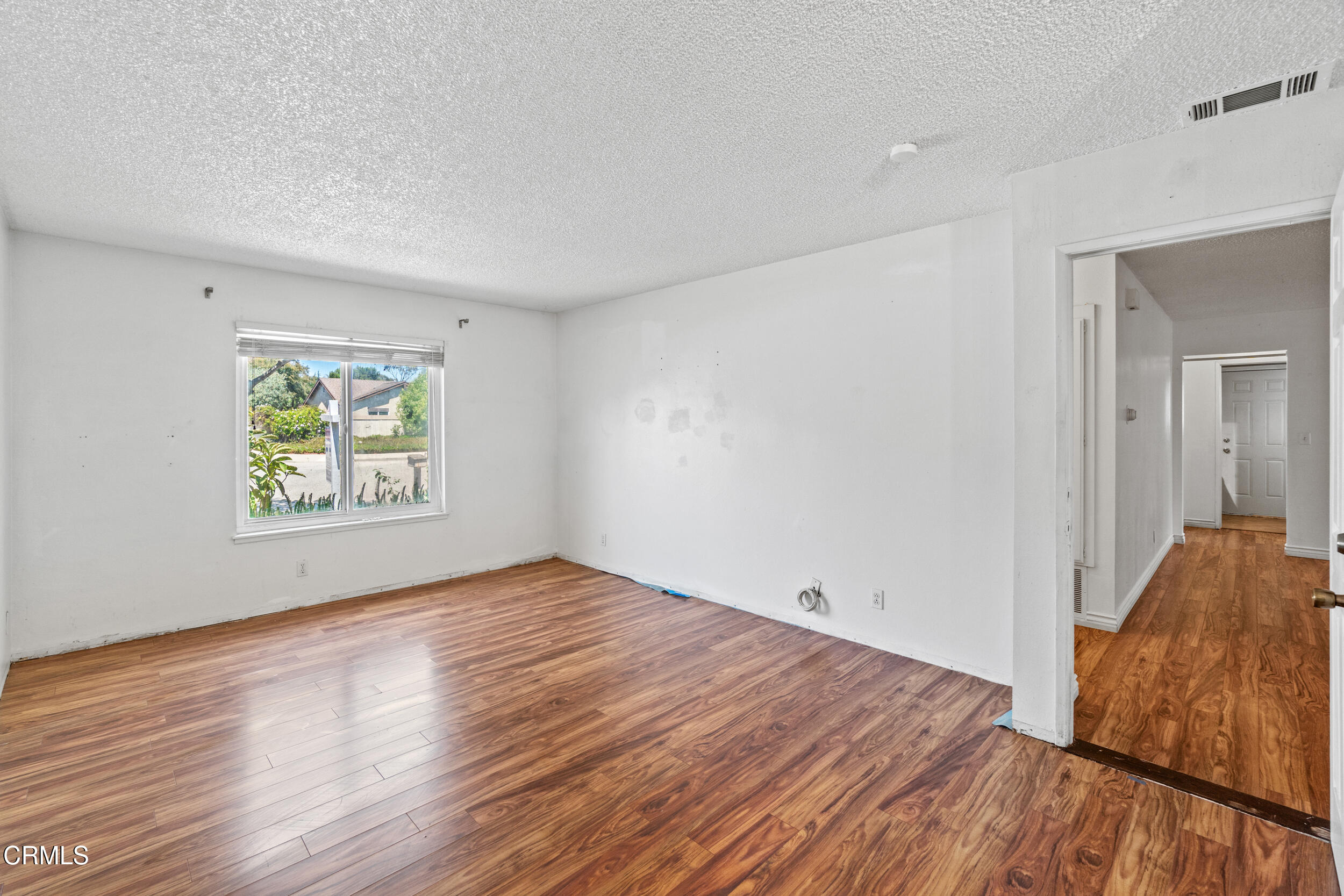 3330 Ketch Avenue Oxnard, CA 93035 - Photo 21 of 45 an empty room with wooden floor and windows