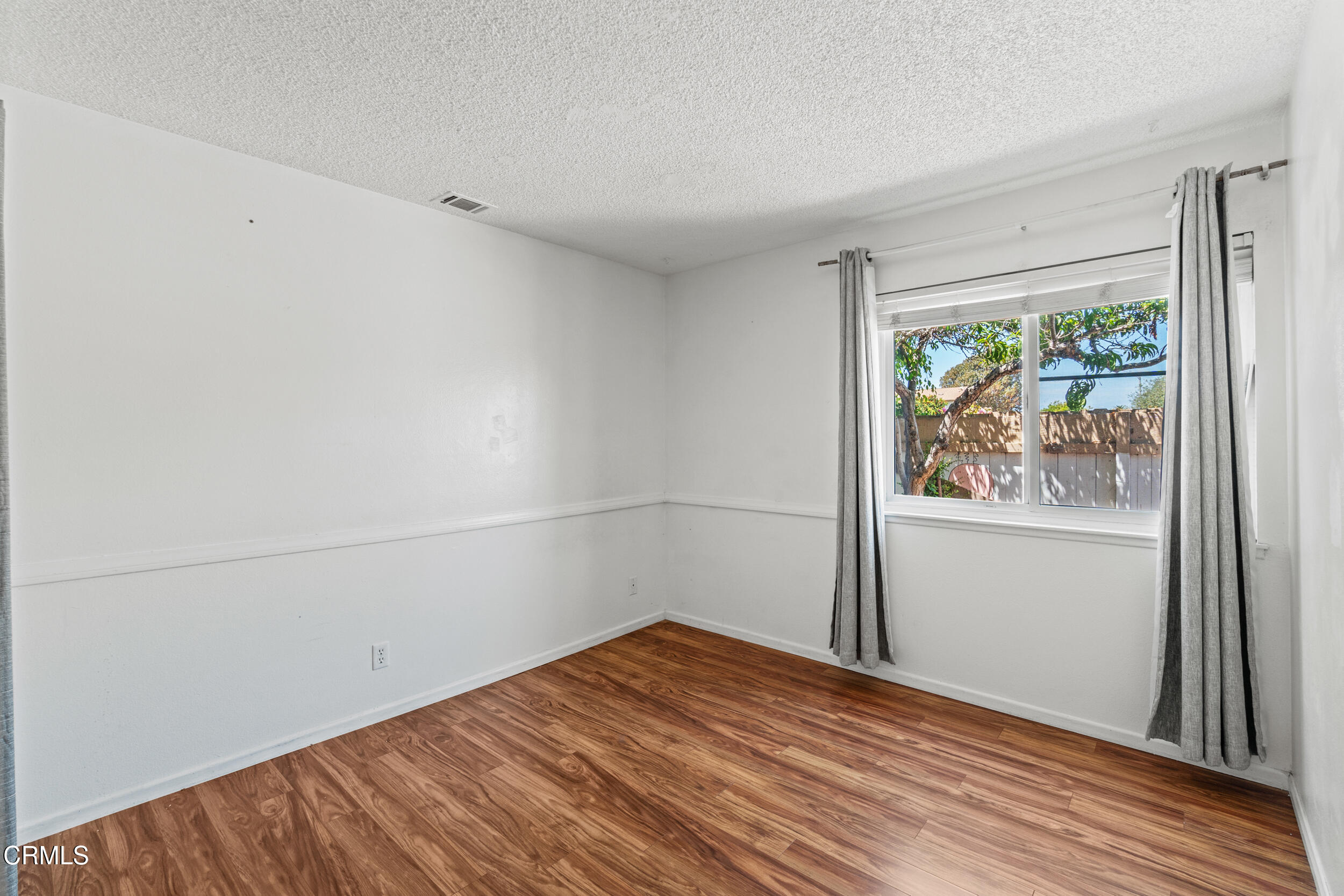 3330 Ketch Avenue Oxnard, CA 93035 - Photo 26 of 45 a view of a room with wooden floor and window
