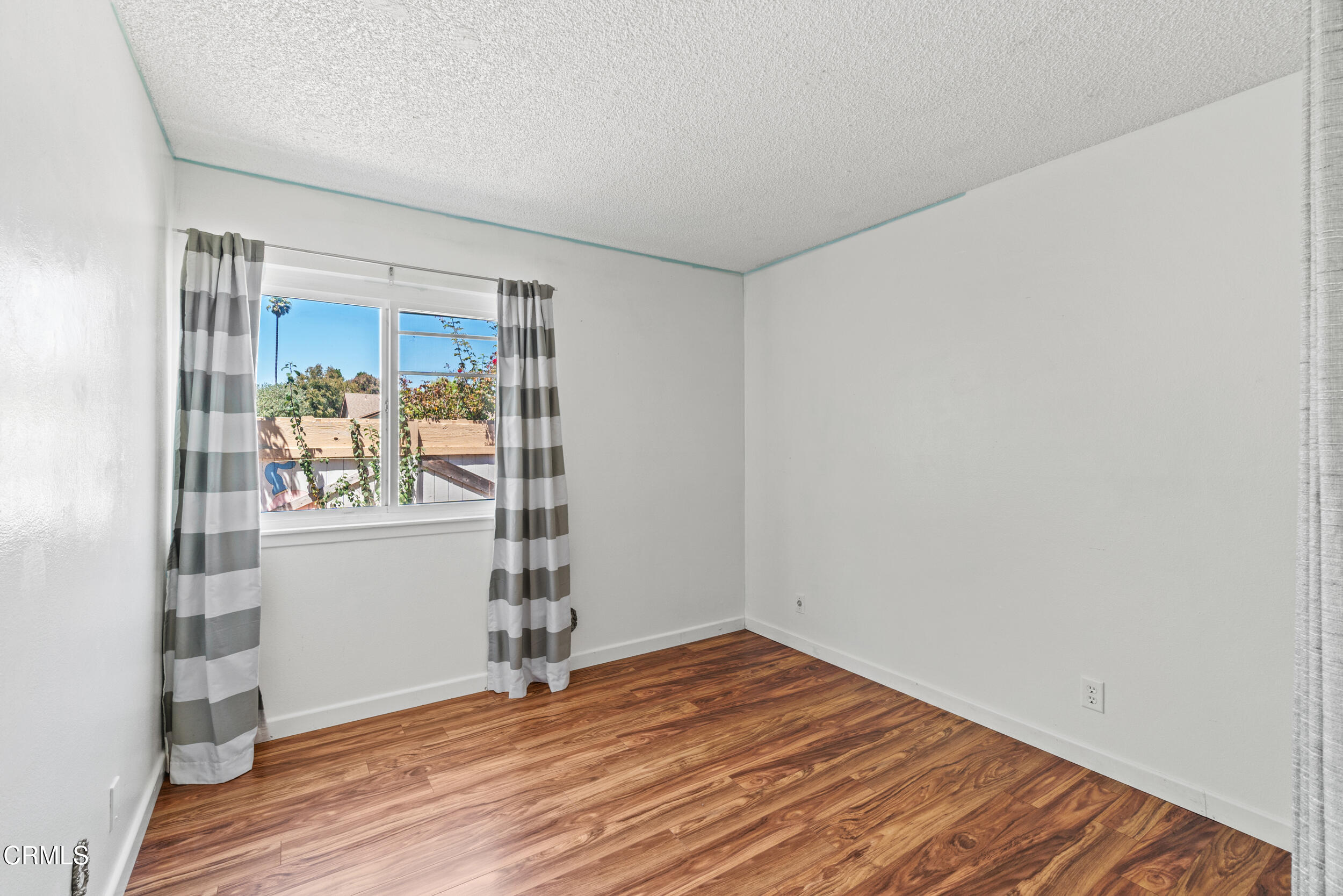 3330 Ketch Avenue Oxnard, CA 93035 - Photo 28 of 45 a view of empty room with wooden floor and fan