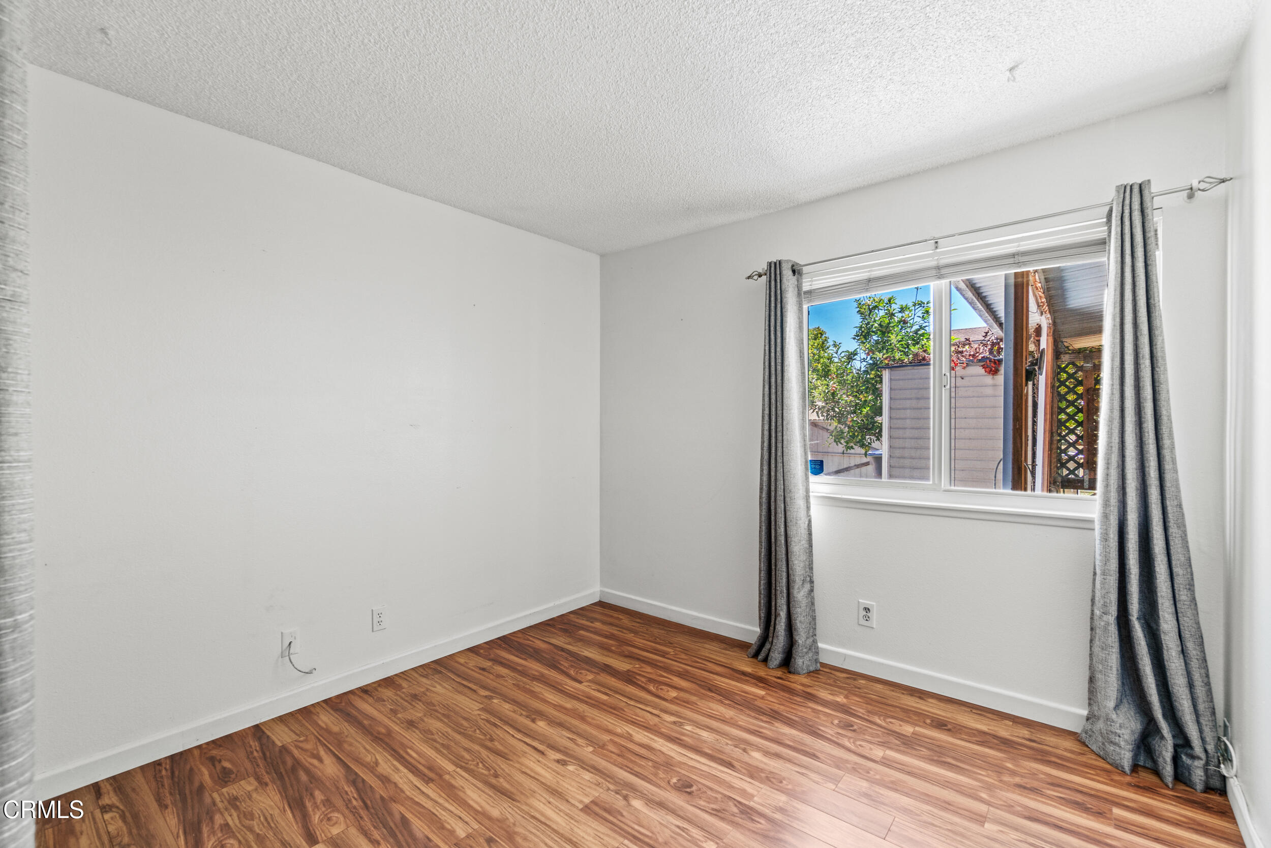 3330 Ketch Avenue Oxnard, CA 93035 - Photo 30 of 45 an empty room with wooden floor and windows