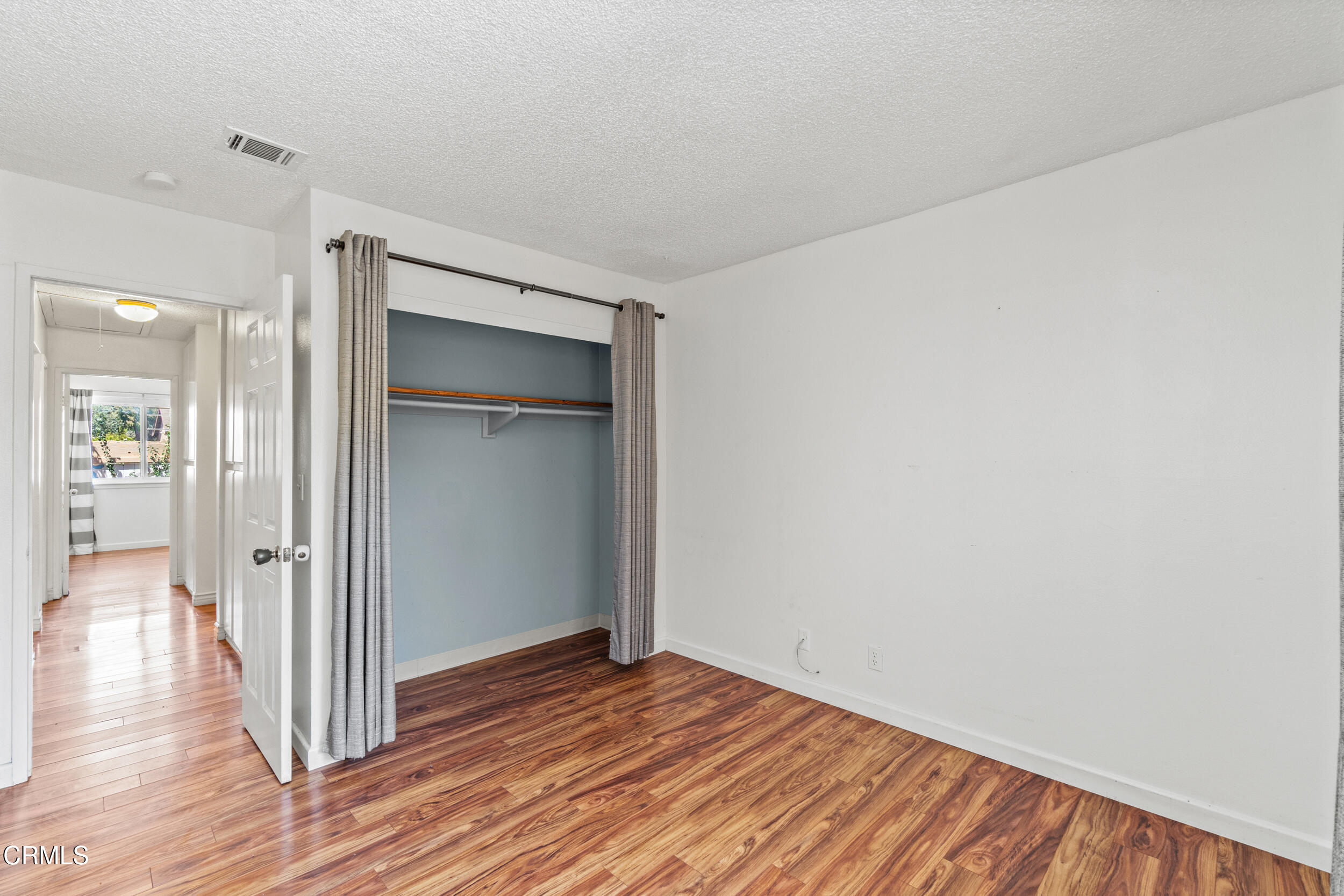 3330 Ketch Avenue Oxnard, CA 93035 - Photo 31 of 45 a view of a hallway with wooden floor