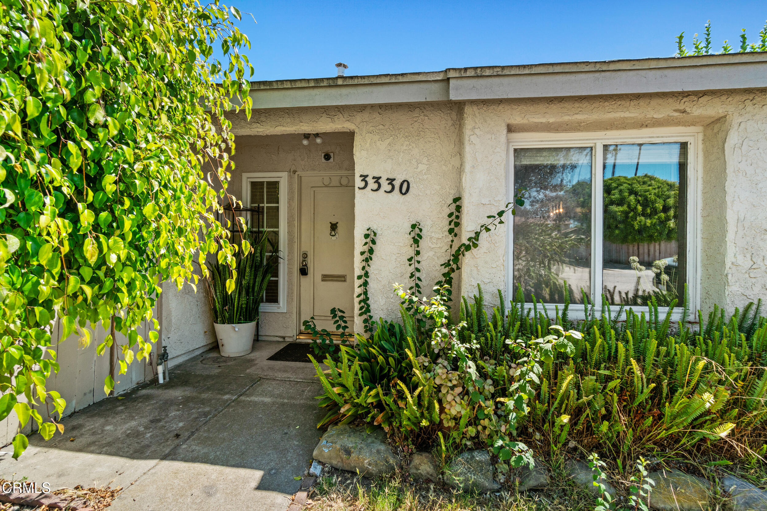 3330 Ketch Avenue Oxnard, CA 93035 - Photo 4 of 45 a front view of a house with a garden