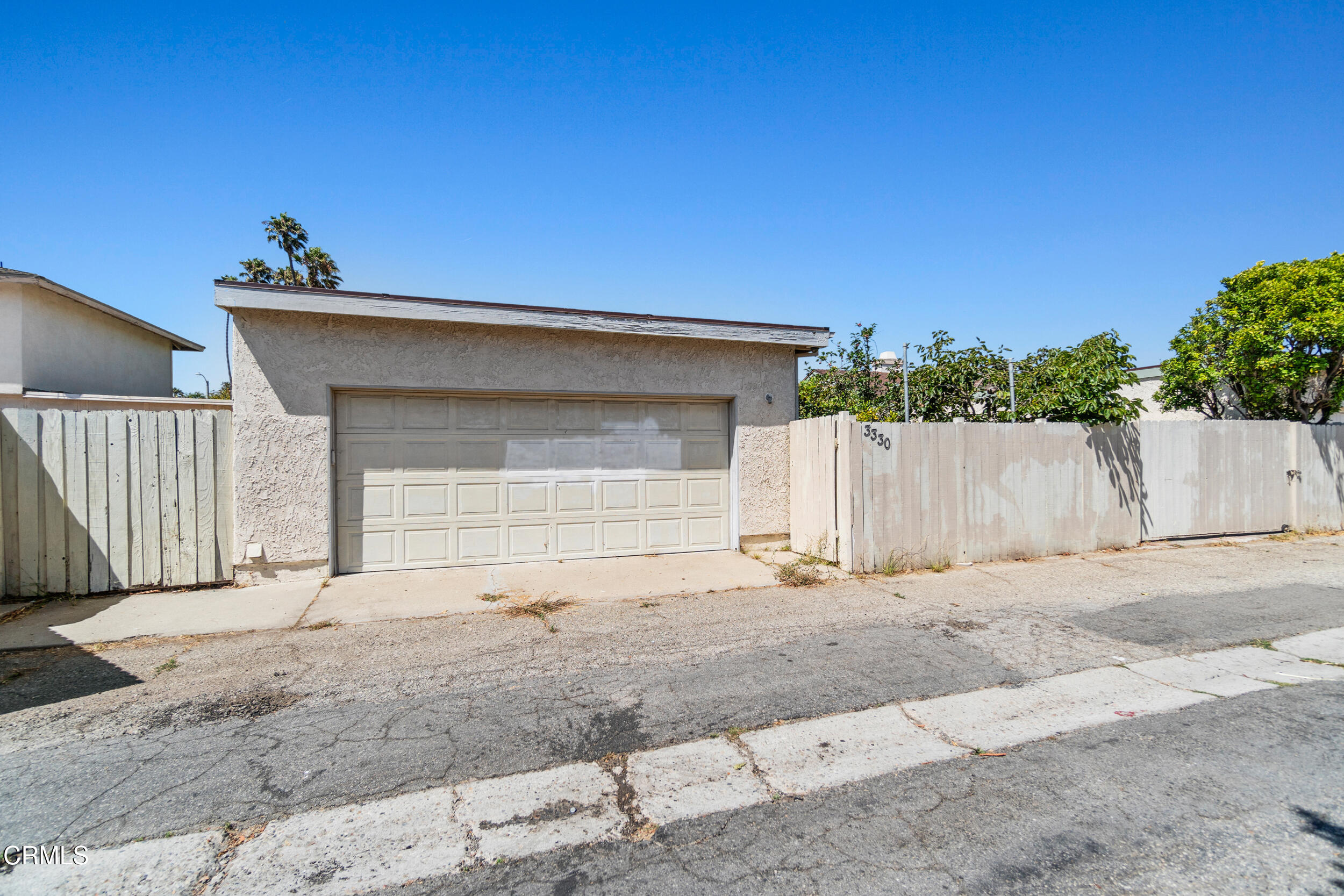 3330 Ketch Avenue Oxnard, CA 93035 - Photo 45 of 45 a front view of a house with a yard and garage