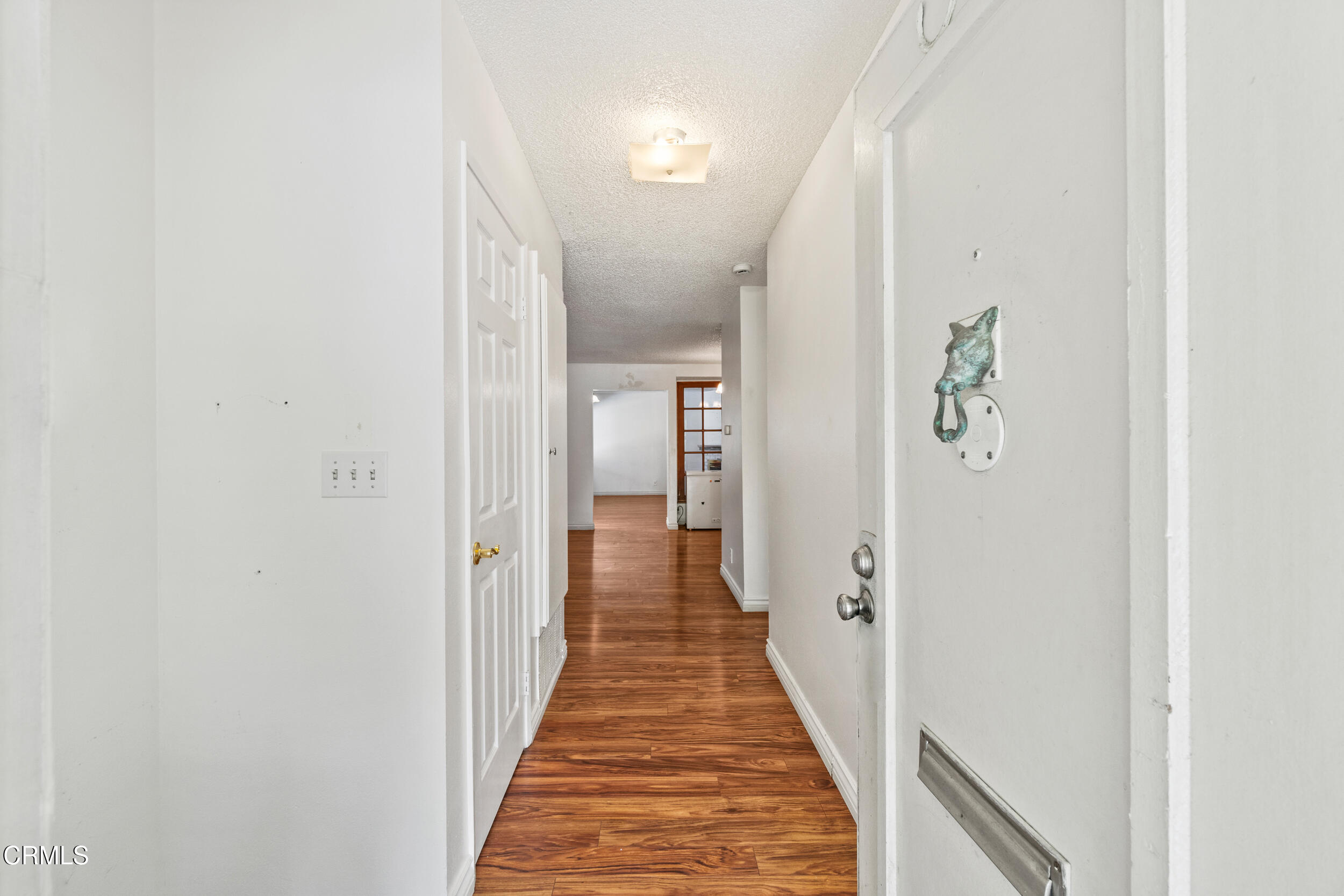 3330 Ketch Avenue Oxnard, CA 93035 - Photo 5 of 45 a view of a hallway with wooden floor