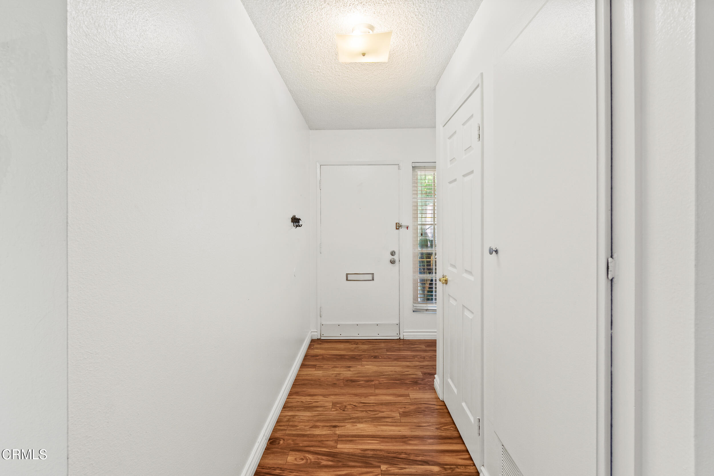 3330 Ketch Avenue Oxnard, CA 93035 - Photo 6 of 45 a view of hallway with wooden floor