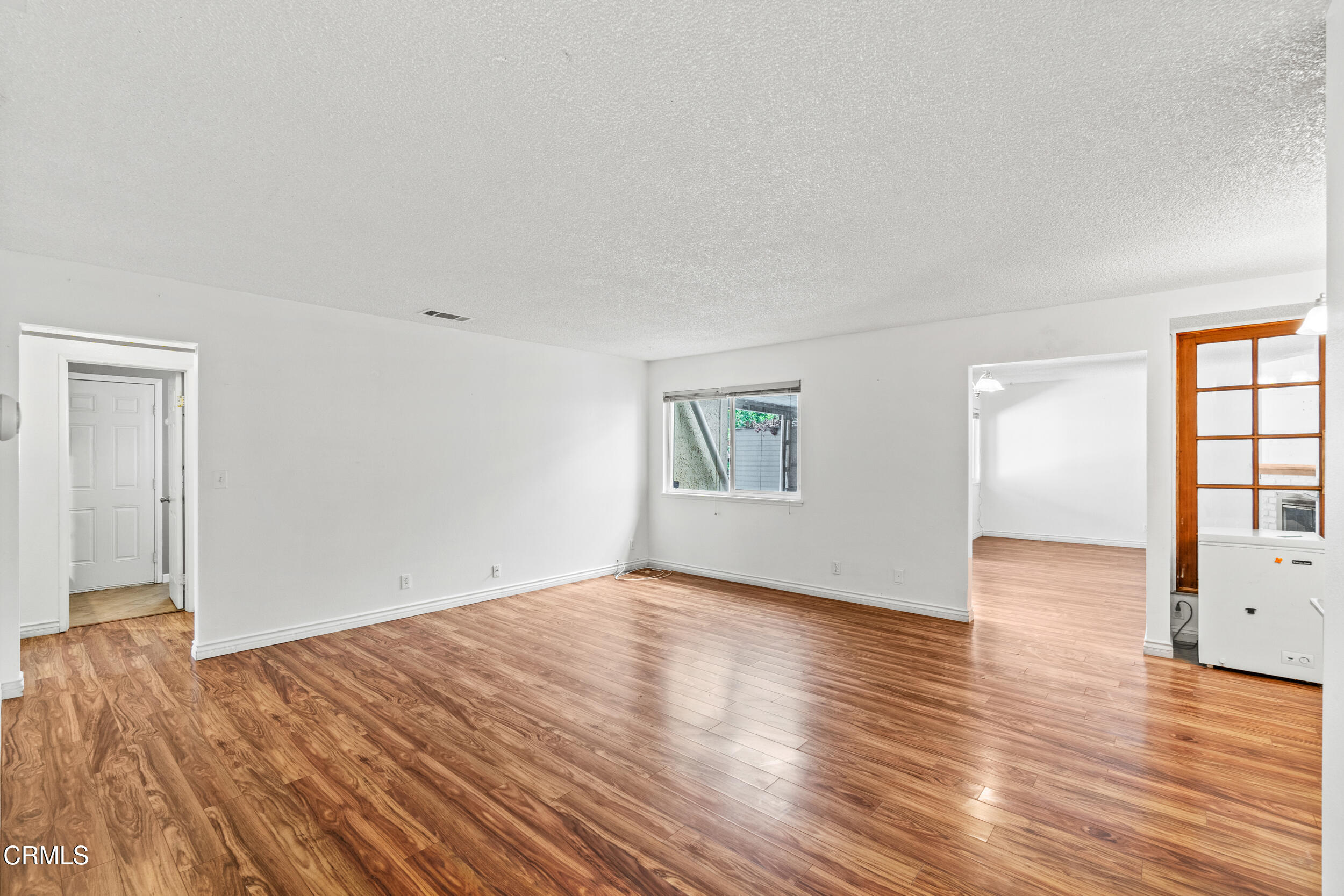 3330 Ketch Avenue Oxnard, CA 93035 - Photo 7 of 45 an empty room with wooden floor and windows