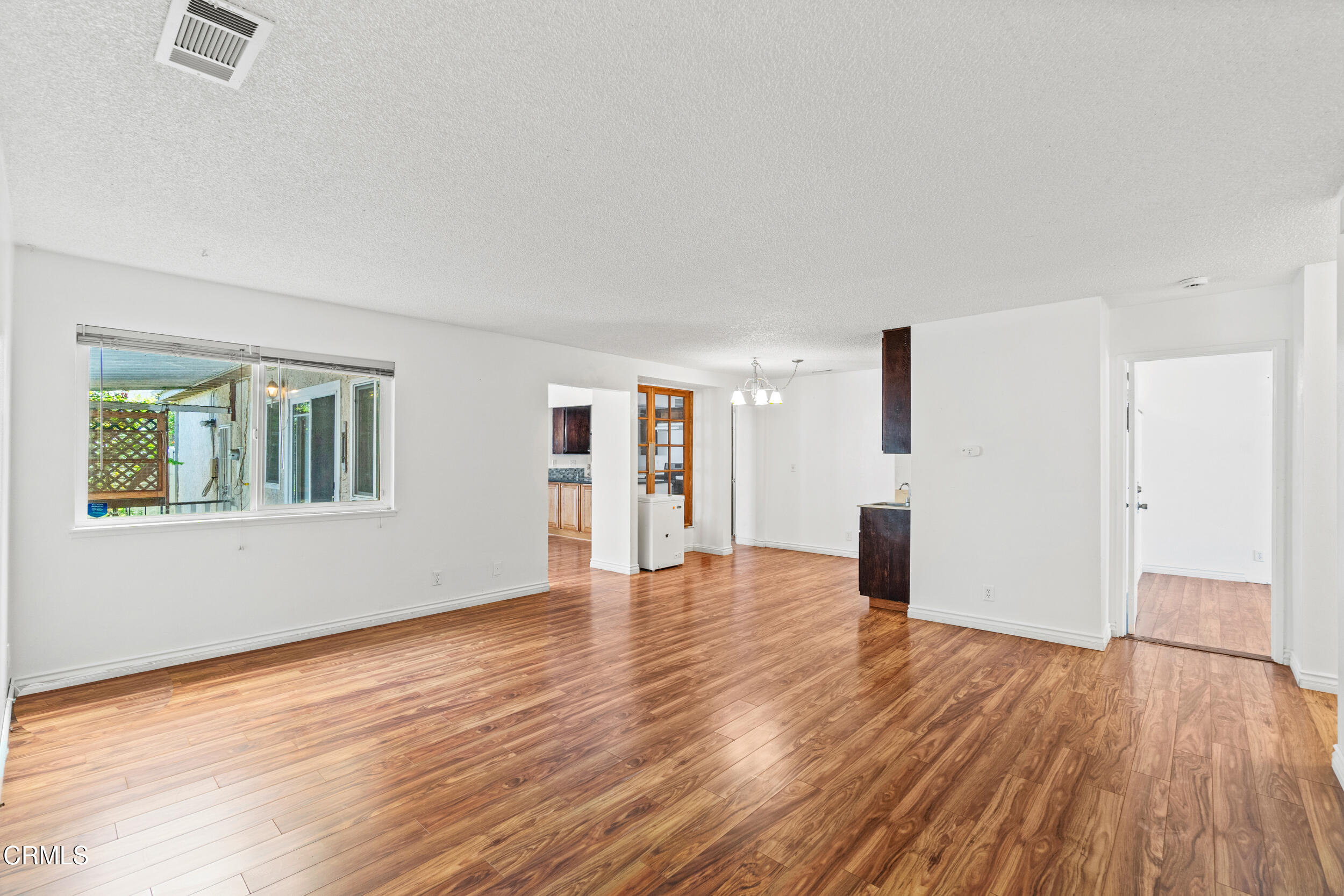 3330 Ketch Avenue Oxnard, CA 93035 - Photo 8 of 45 a view of empty room with wooden floor and window