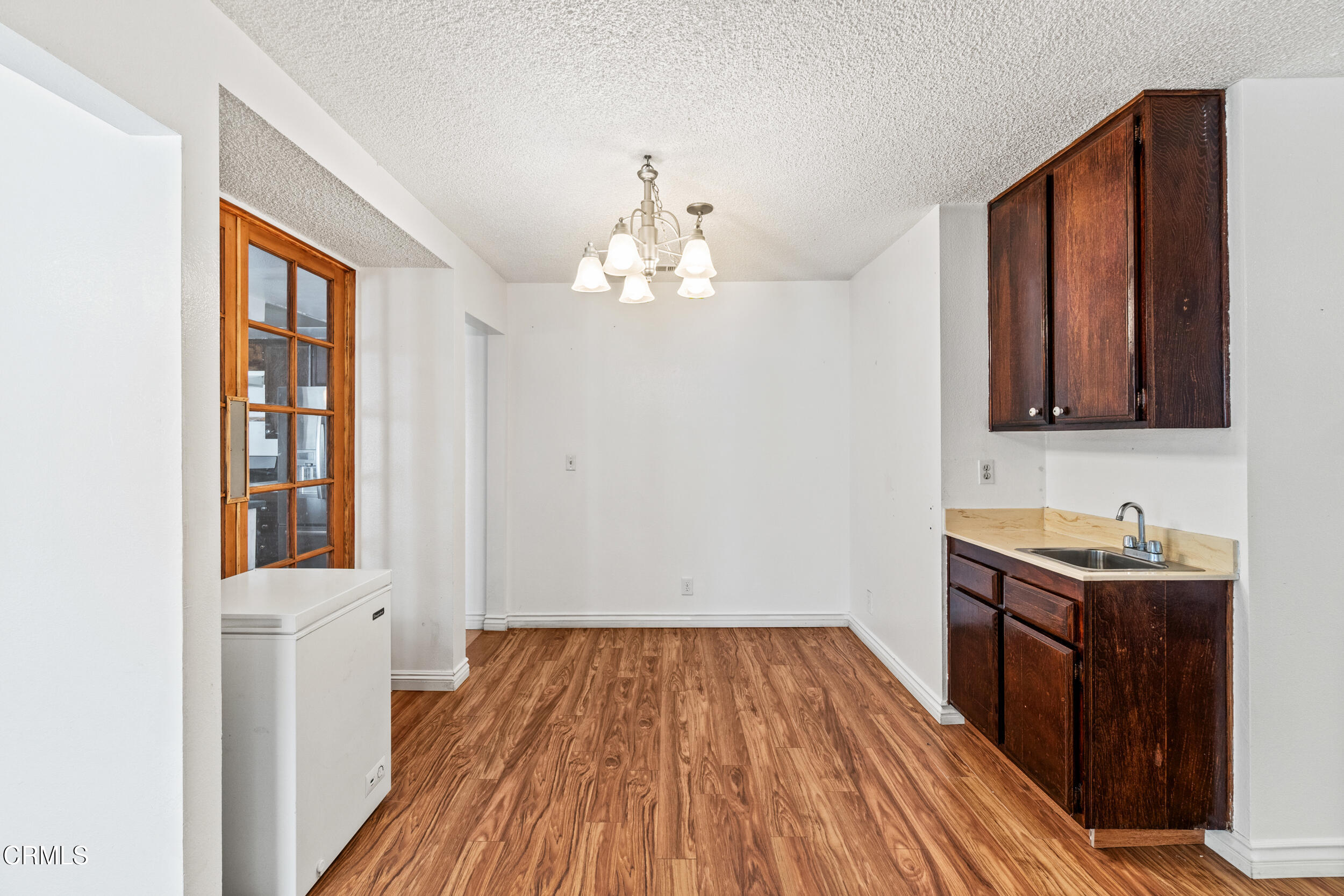 3330 Ketch Avenue Oxnard, CA 93035 - Photo 10 of 45 a room with wooden floor and cabinets