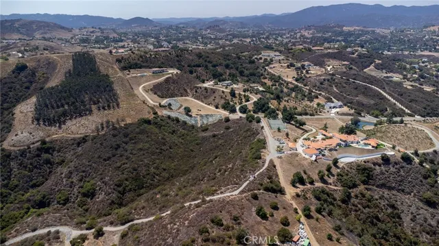 an aerial view of residential house and sandy dunes