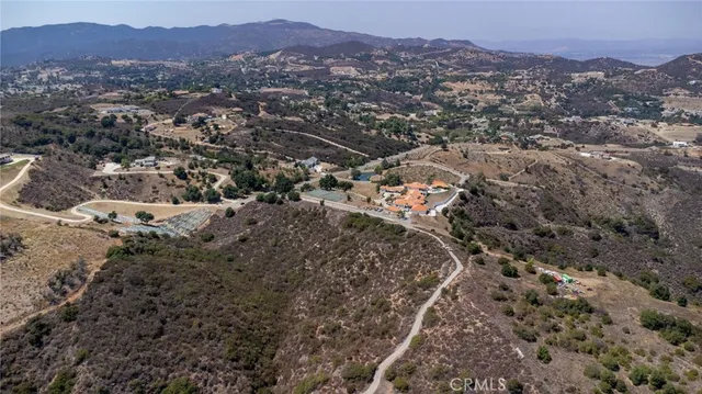 an aerial view of residential house and sandy dunes