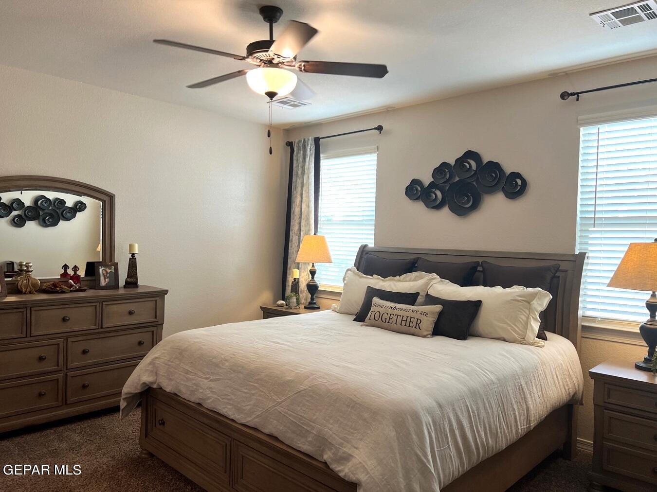 12869 Crystal Downs El Paso, TX 79928 - Photo 12 of 18 a bedroom with a bed and a chandelier