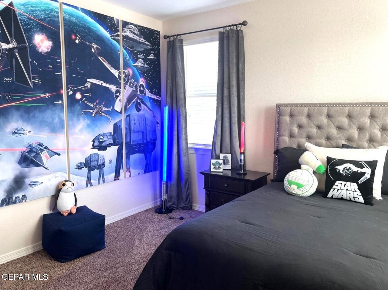 12869 Crystal Downs El Paso, TX 79928 - Photo 7 of 18 a bedroom with a bed and a chandelier