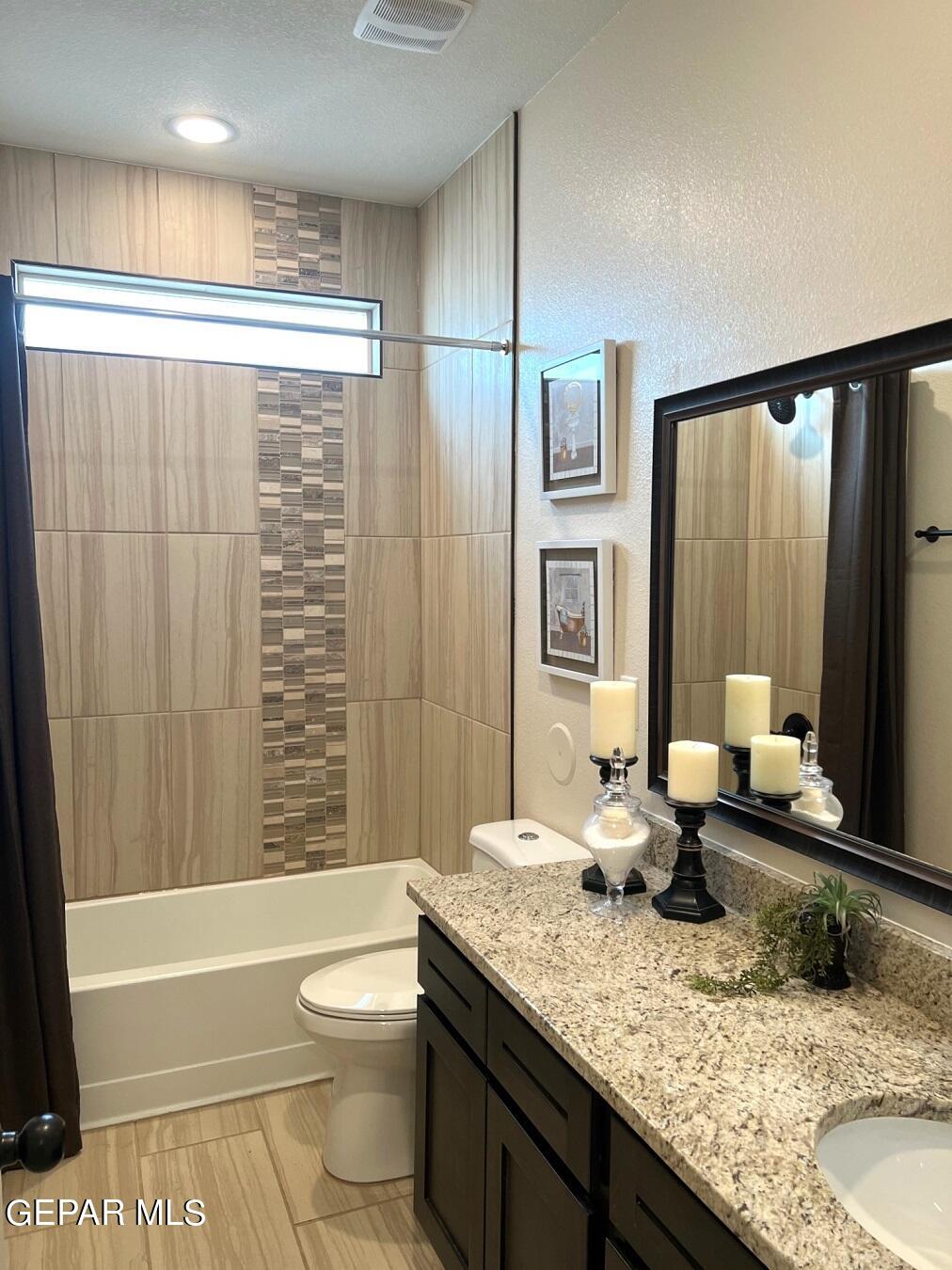12869 Crystal Downs El Paso, TX 79928 - Photo 9 of 18 a bathroom with a granite countertop sink toilet and shower