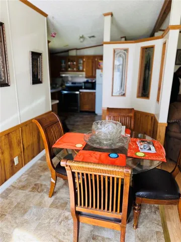 a dining room with furniture and wooden floor