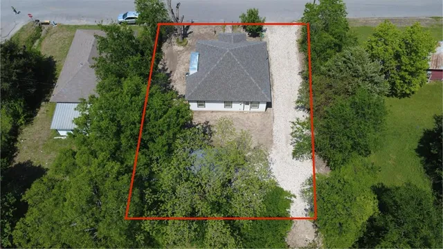 an aerial view of a house with outdoor space and street view