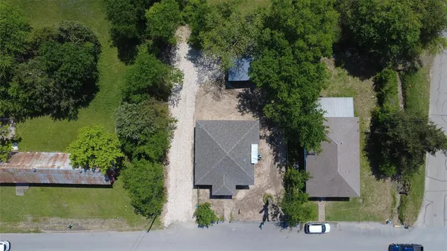 an aerial view of a house with garden space and a lake view