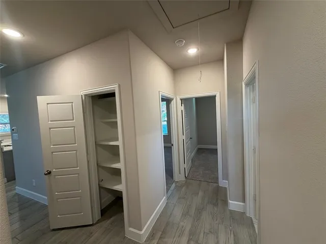 a view of walk in closet with wooden floor