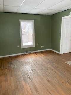 3213 Gideon Avenue Zion, IL 60099 - Photo 5 of 15 an empty room with wooden floor and windows