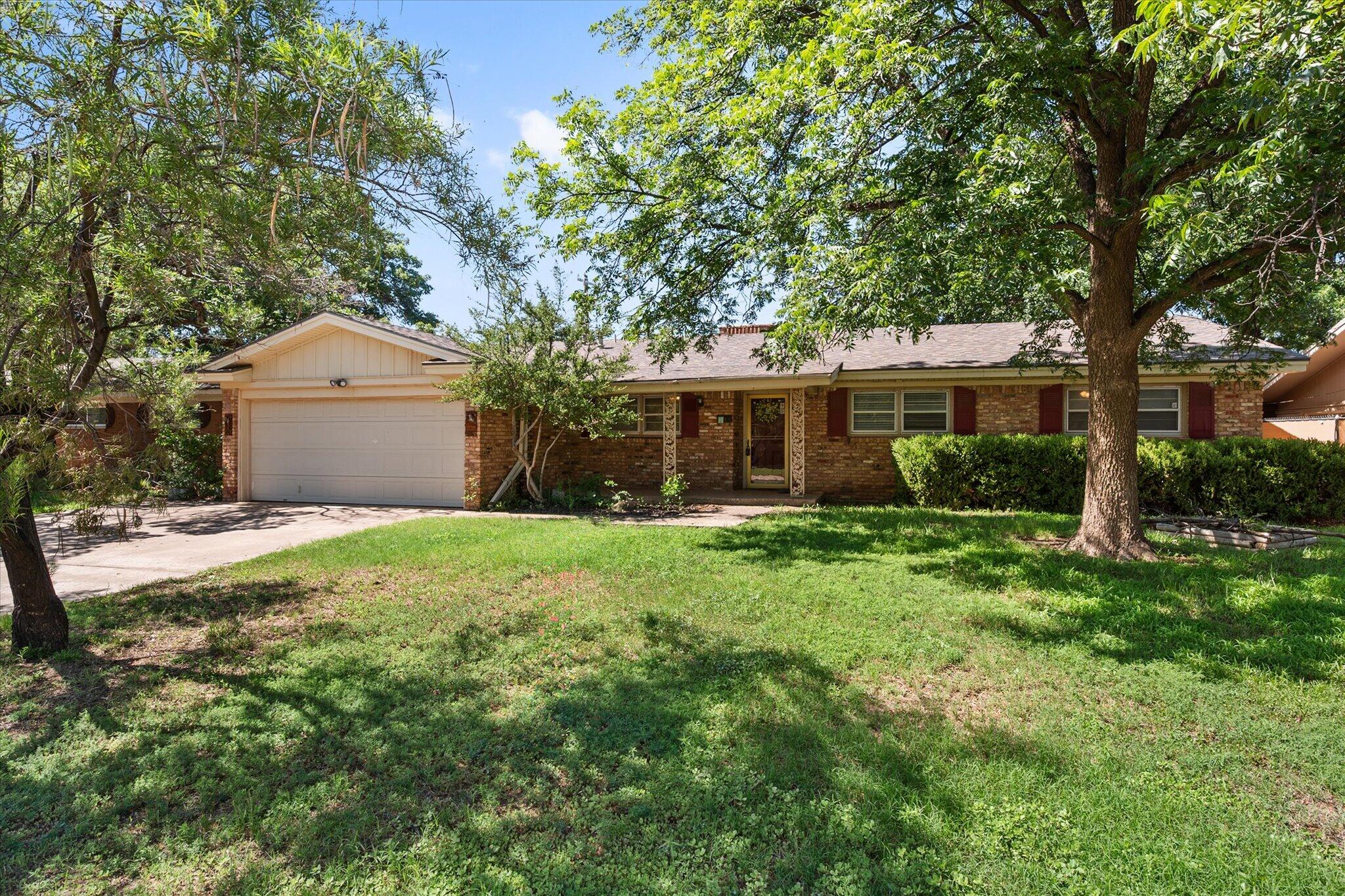 4604 27th Street Lubbock, TX 79410 - Photo 3 of 36 front view of a house with a yard