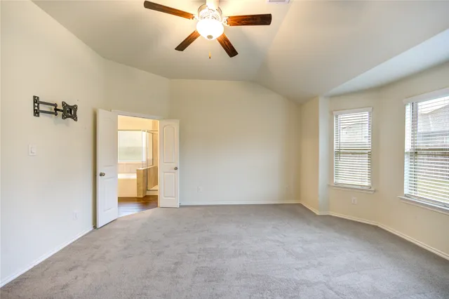 a view of a livingroom with a ceiling fan and window