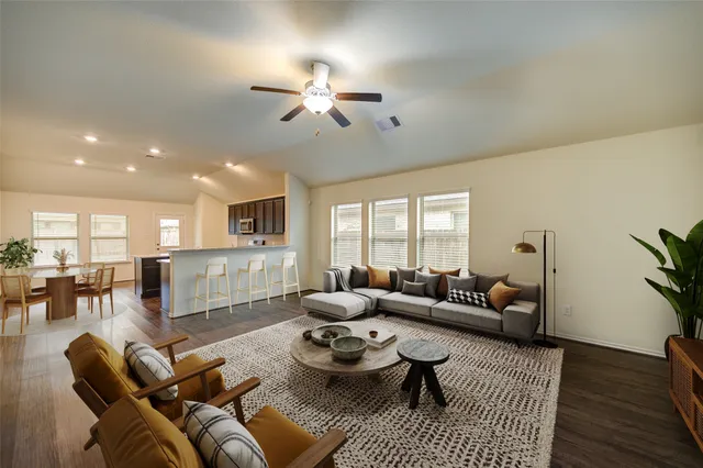 a living room with furniture and wooden floor