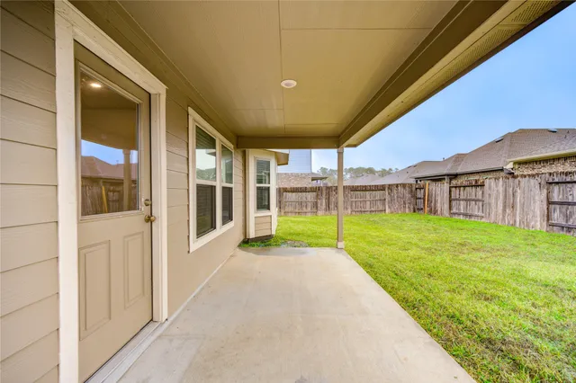a view of a house with backyard and porch