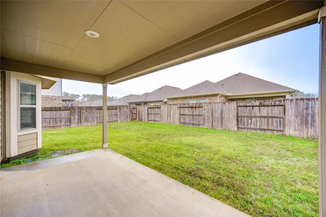 a view of a backyard with wooden fence